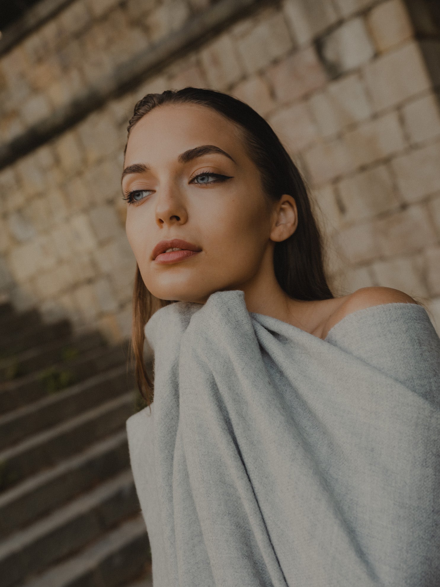 Model wearing Grey knit poncho made from baby alpaca