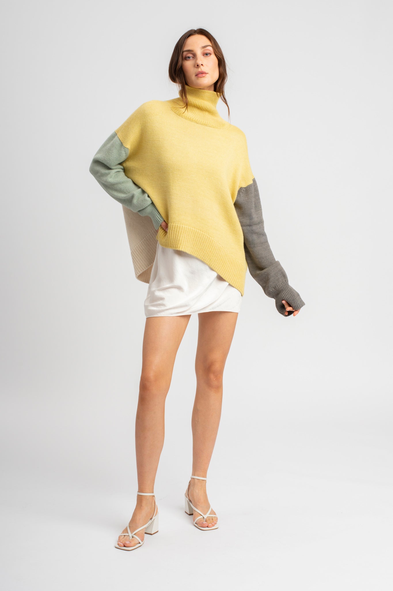 Model wearing turtleneck oversized sweater in multi-color yellow alpaca wool, front standing