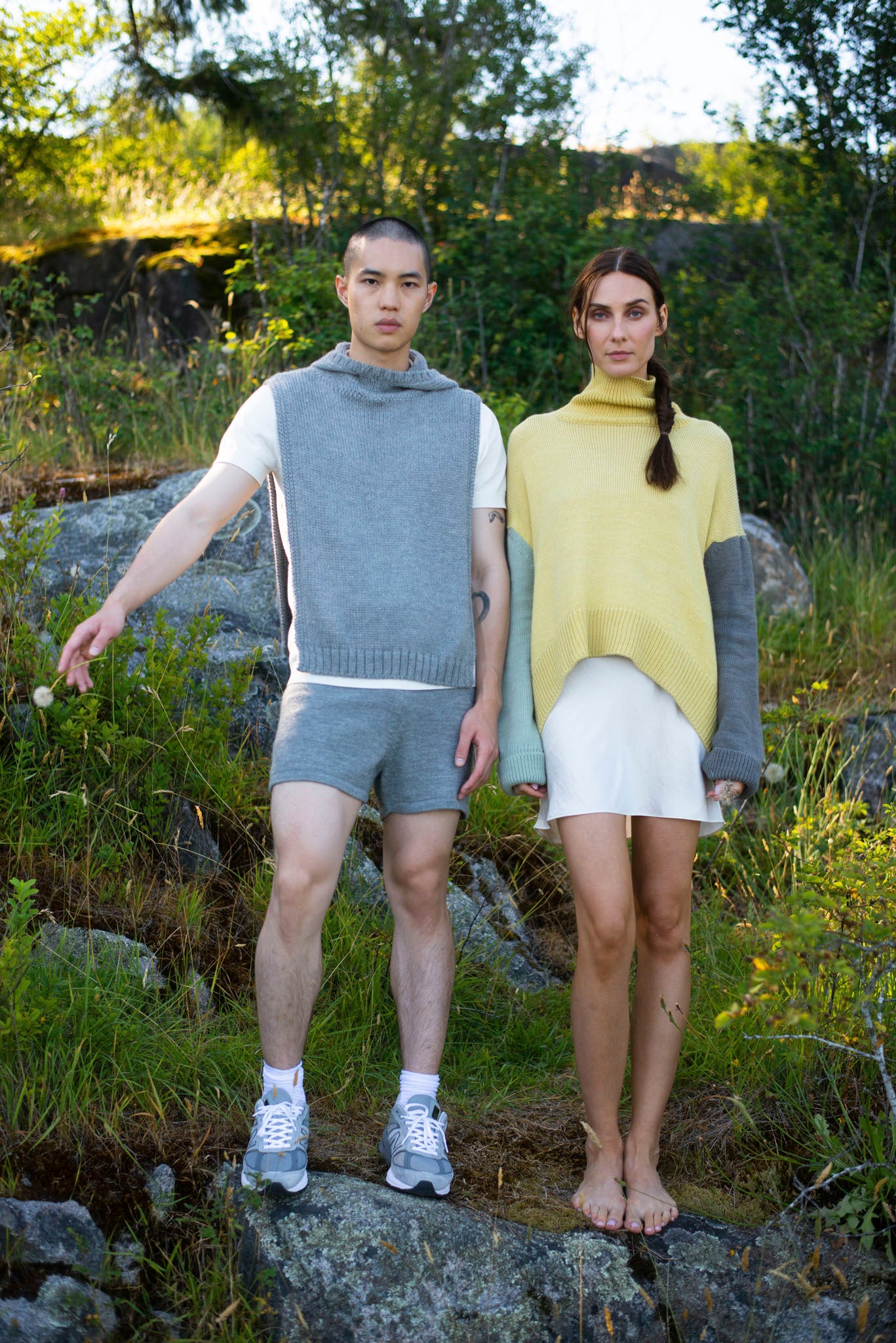 Model wearing turtleneck oversized sweater in multi-color yellow alpaca wool, standing front