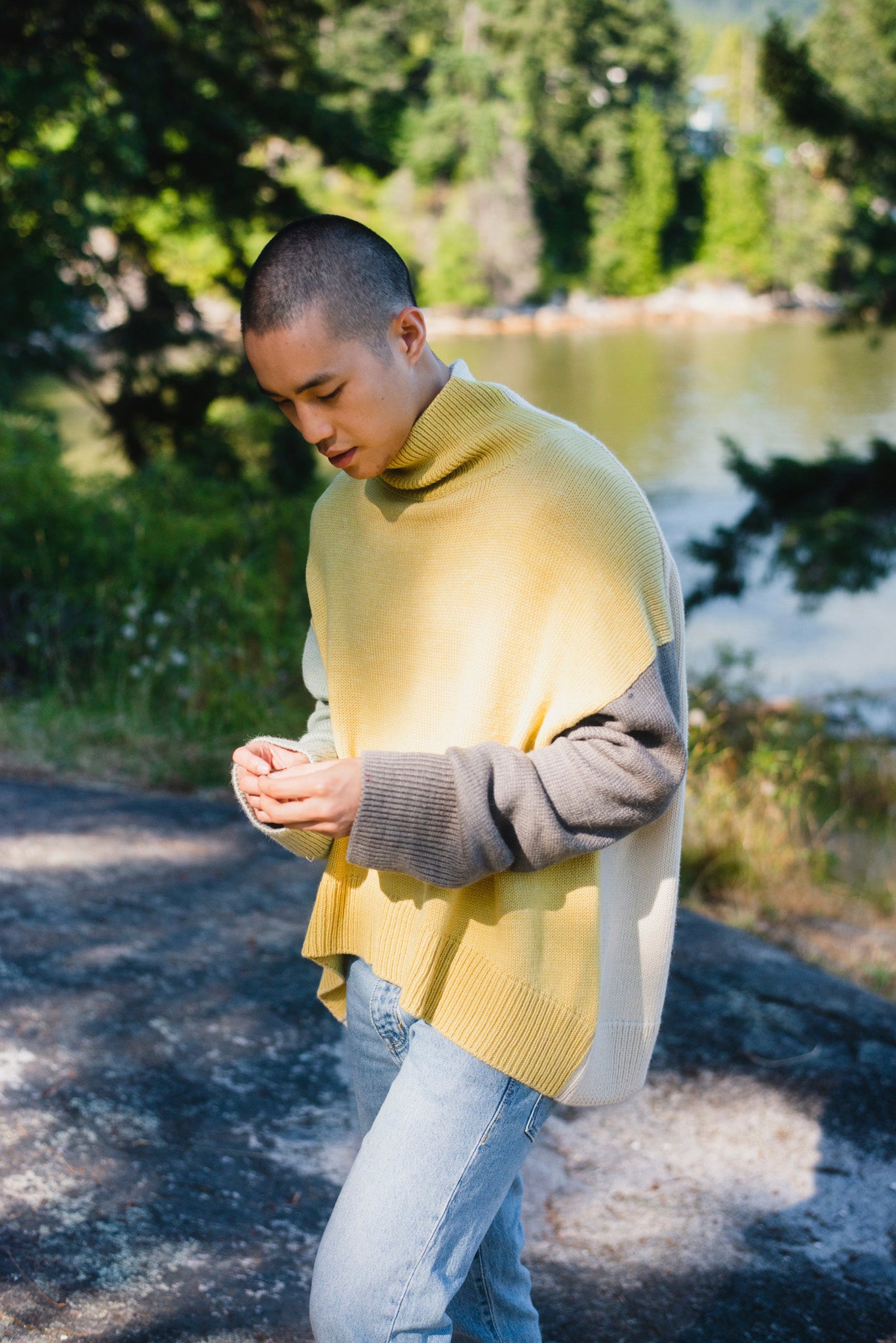 Model wearing turtleneck oversized sweater in multi-color yellow alpaca wool, side