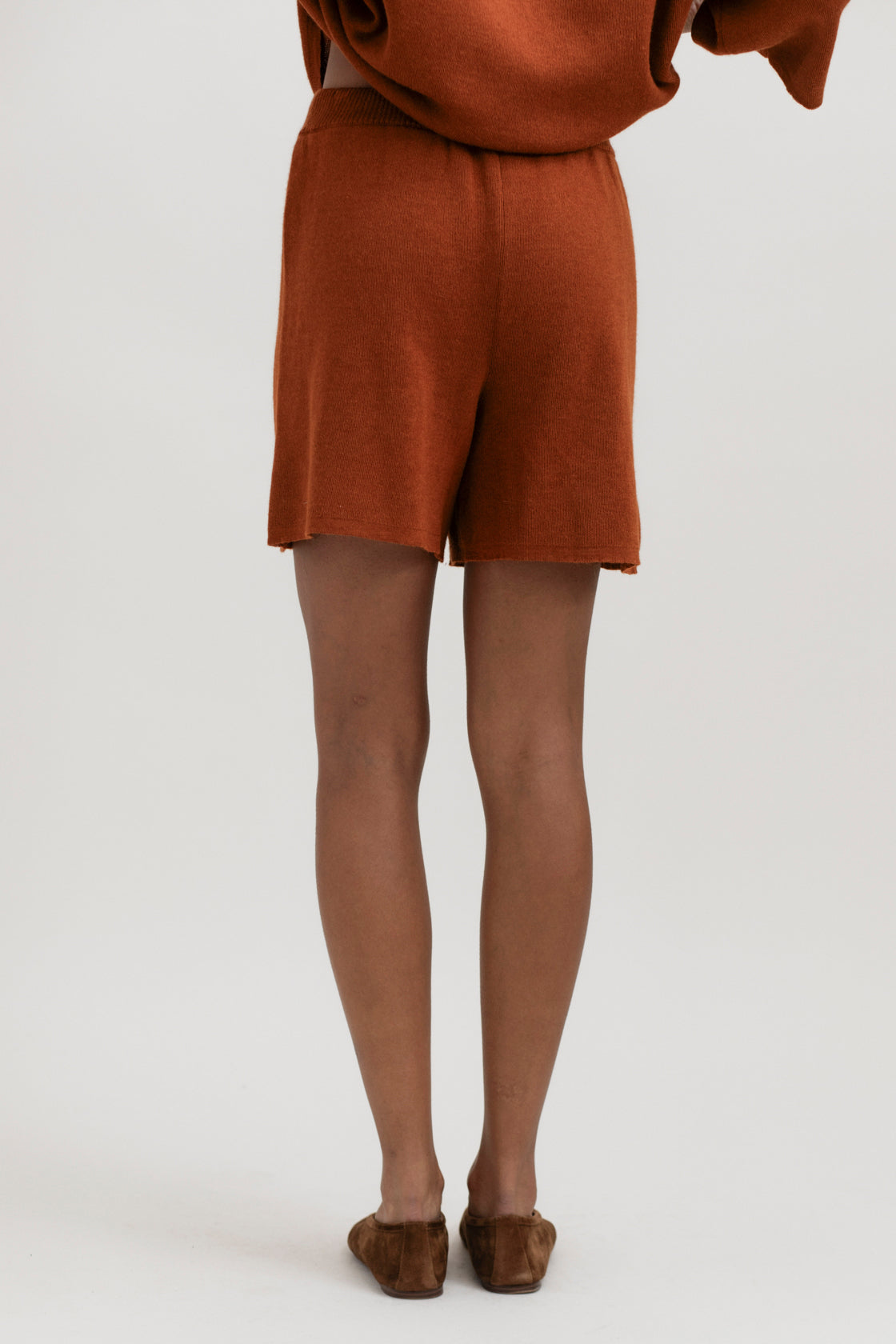 Airy Shorts in Burnt Orange, alpaca and silk knit shorts by Ahblo, worn by model
