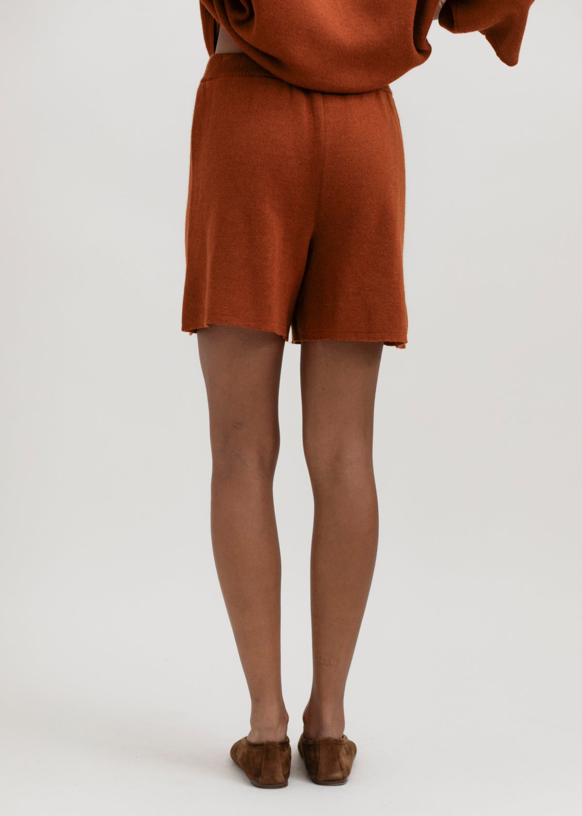 Airy Shorts in Burnt Orange, alpaca and silk knit shorts by Ahblo, worn by model
