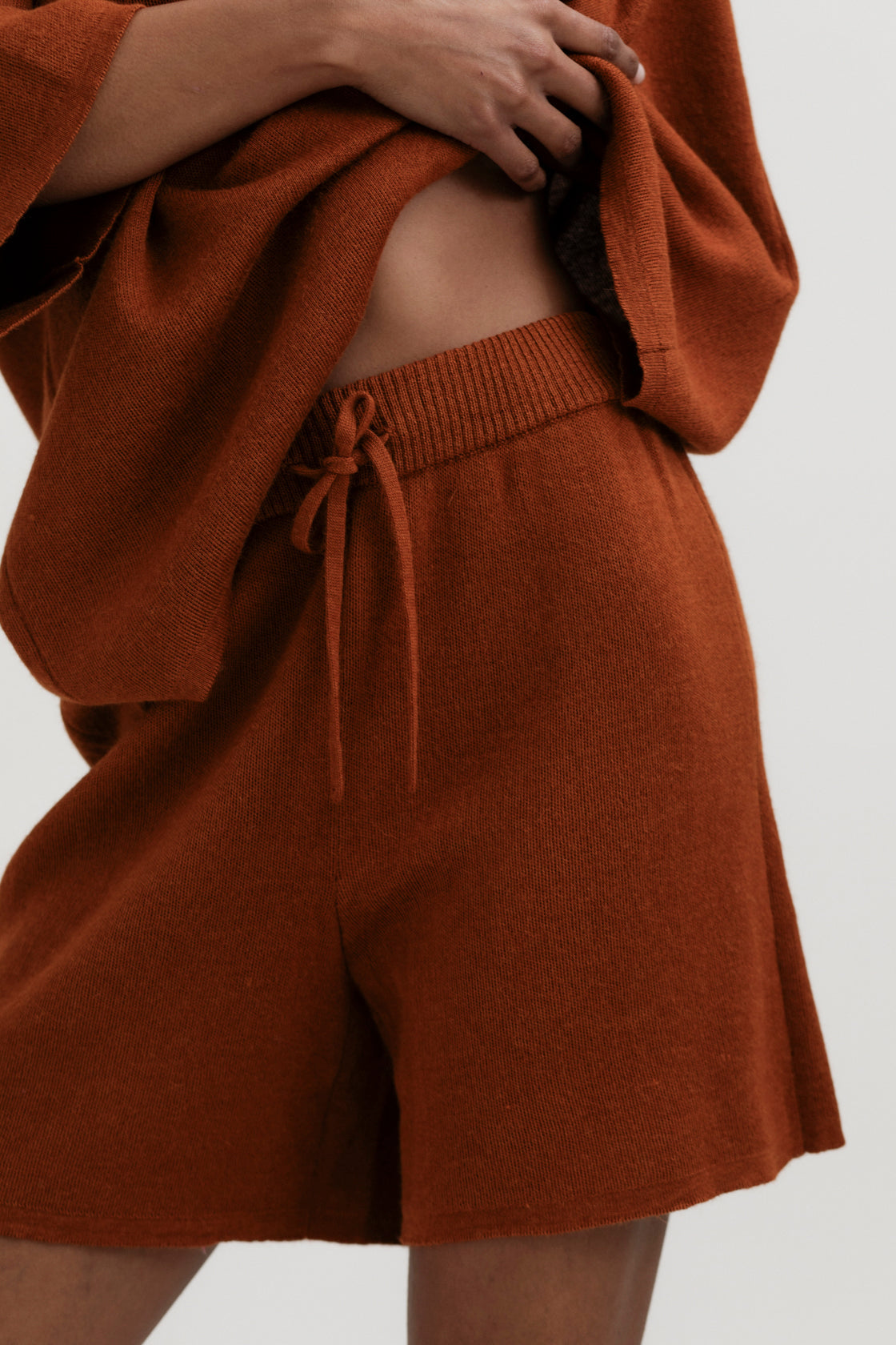 Airy Shorts in Burnt Orange, alpaca and silk knit shorts by Ahblo, worn by model