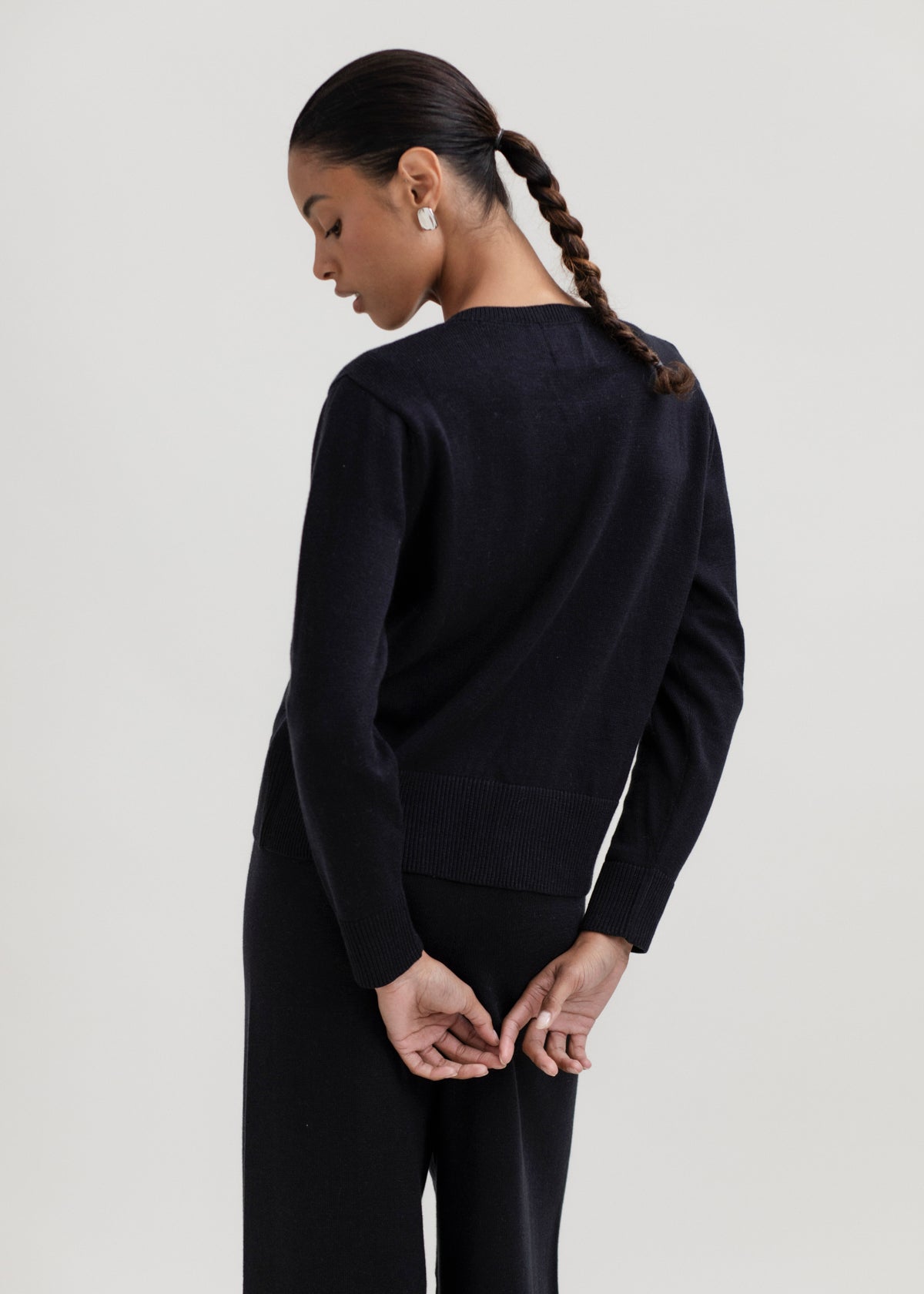 Amaya Cardigan in Black, cotton and baby alpaca bow cardigan by Ahblo, worn by model