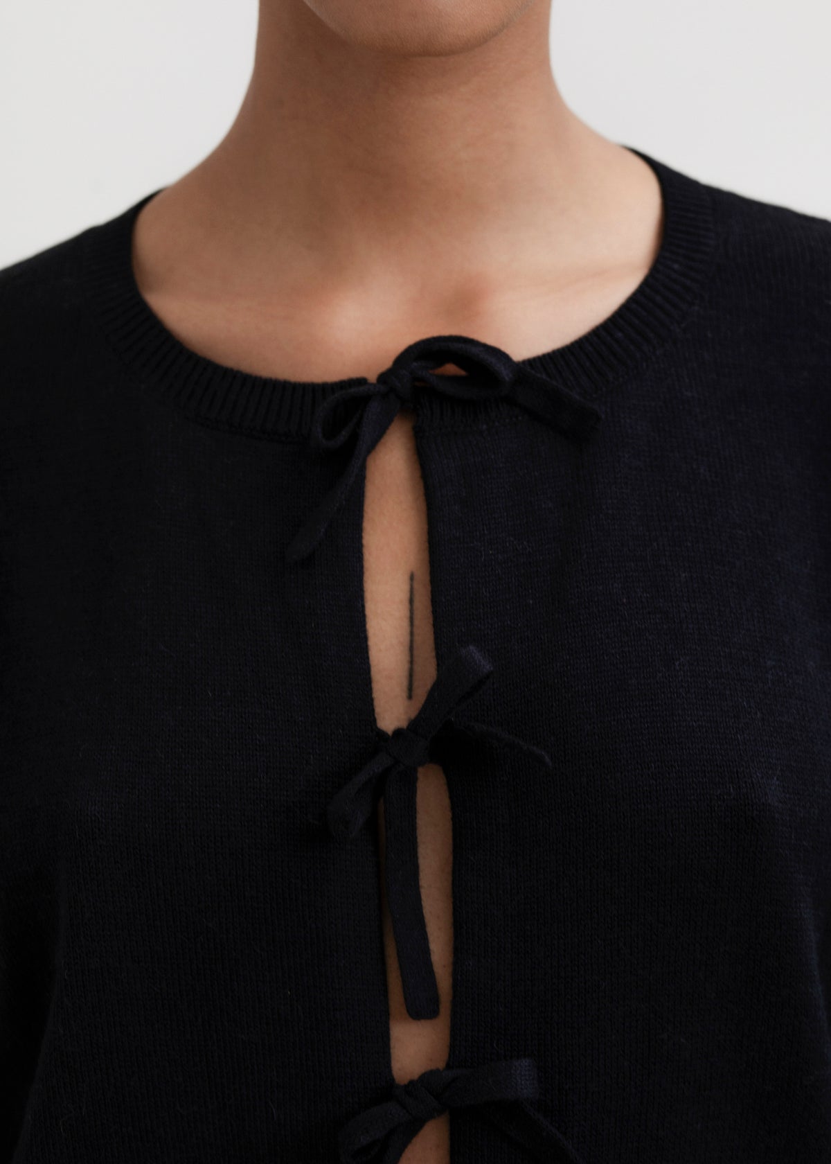 Amaya Cardigan in Black, cotton and baby alpaca bow cardigan by Ahblo, worn by model