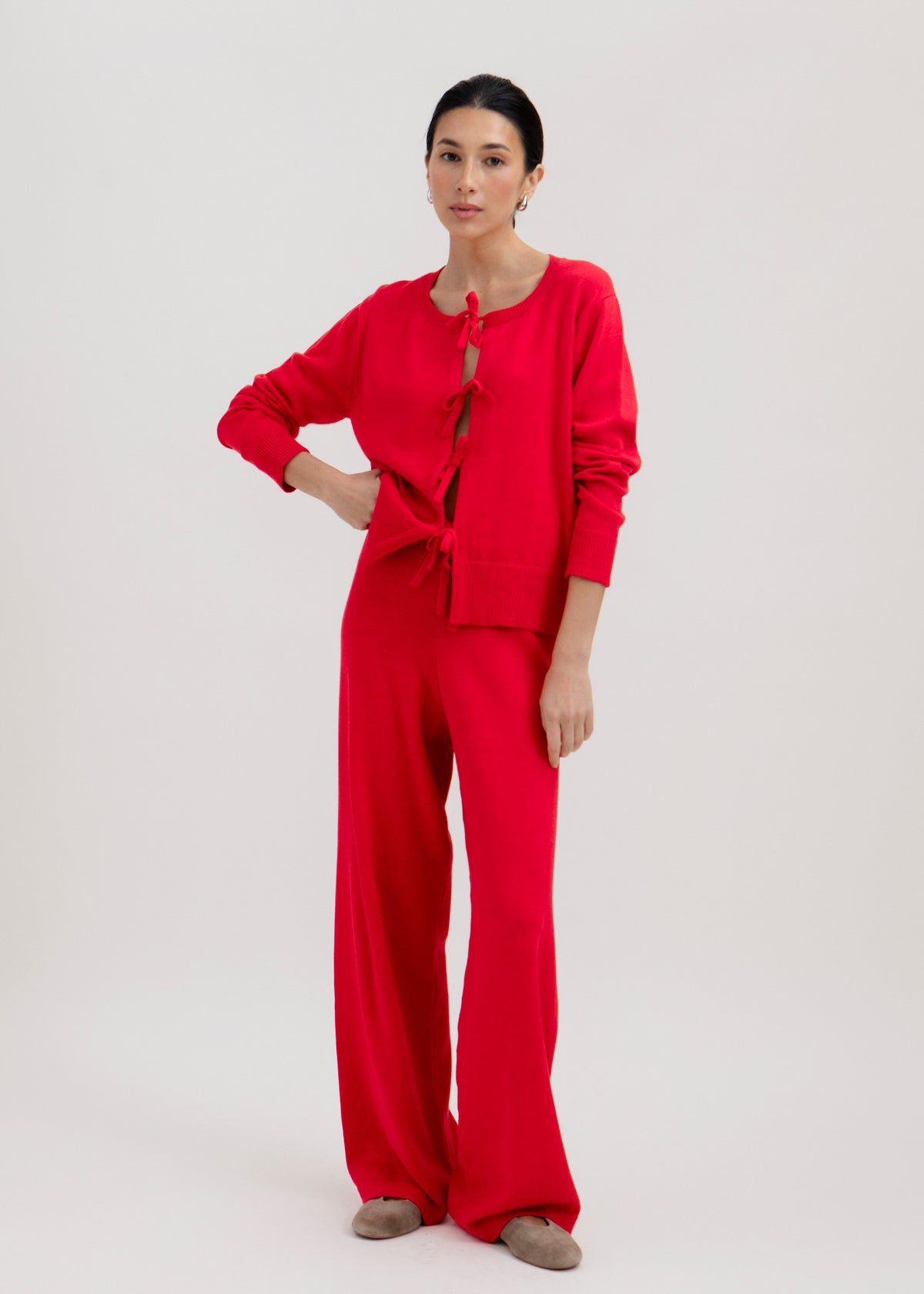 Amaya Cardigan in Cerise, cotton and baby alpaca bow cardigan by Ahblo, worn by model