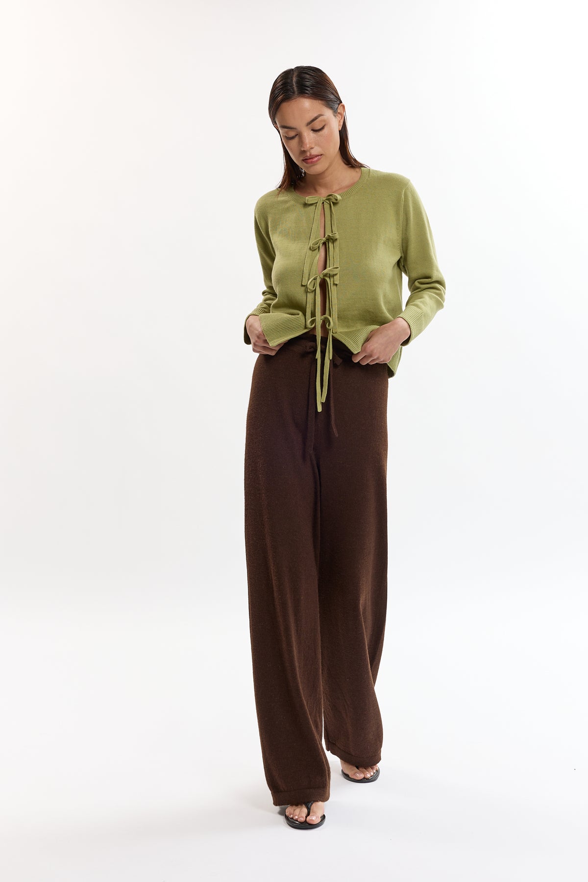 Amaya Cardigan in Olive, cotton and baby alpaca bow cardigan by Ahblo, worn by model