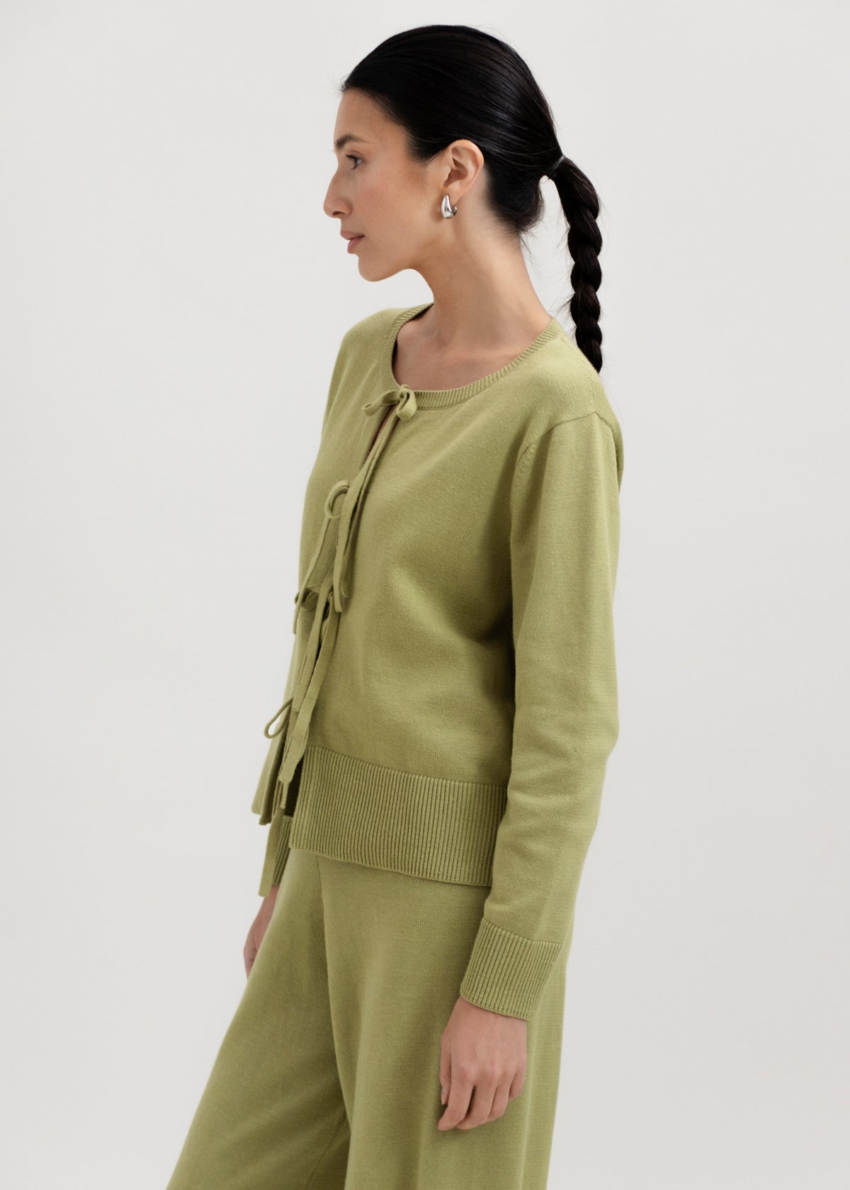 Amaya Cardigan in Olive, cotton and baby alpaca bow cardigan by Ahblo, worn by model