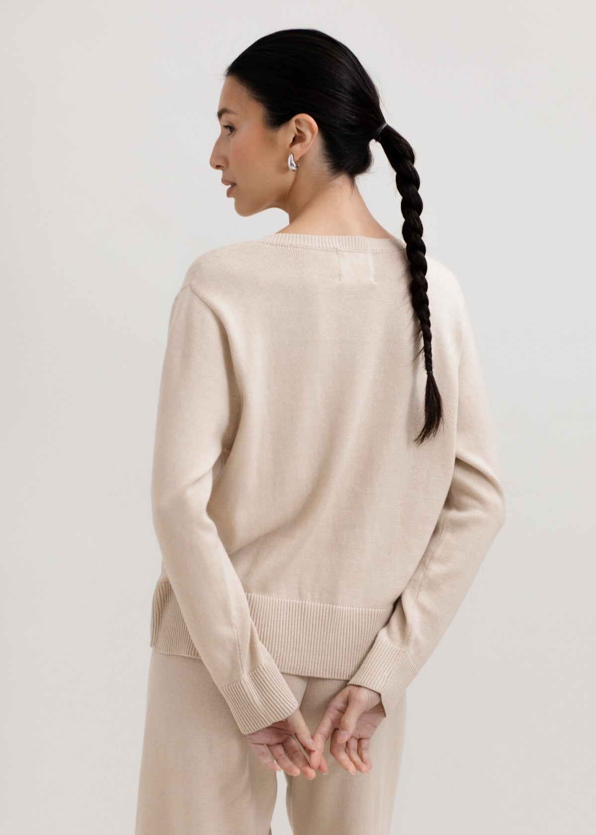 Amaya Cardigan in Praline, cotton and baby alpaca bow cardigan by Ahblo, worn by model