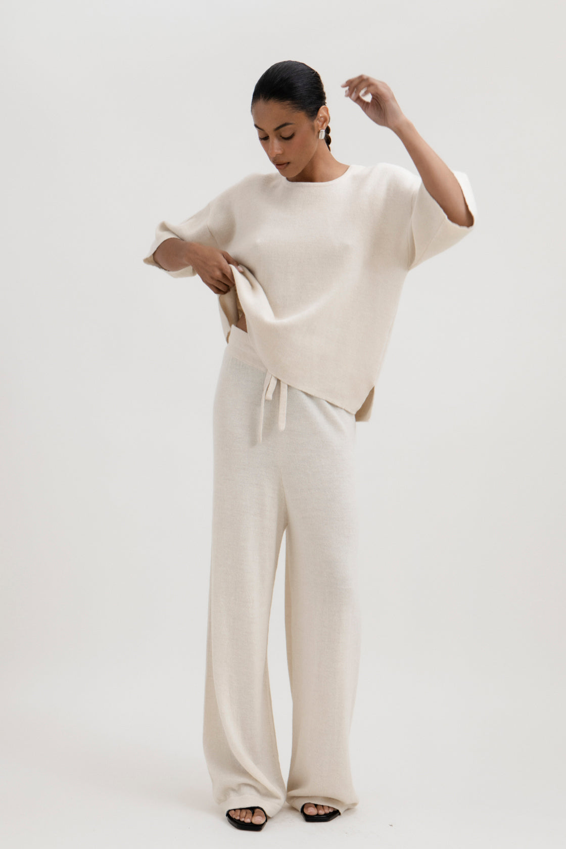 Avery Trousers in Cream, baby alpaca wide-leg knit trousers by Ahblo, worn by model