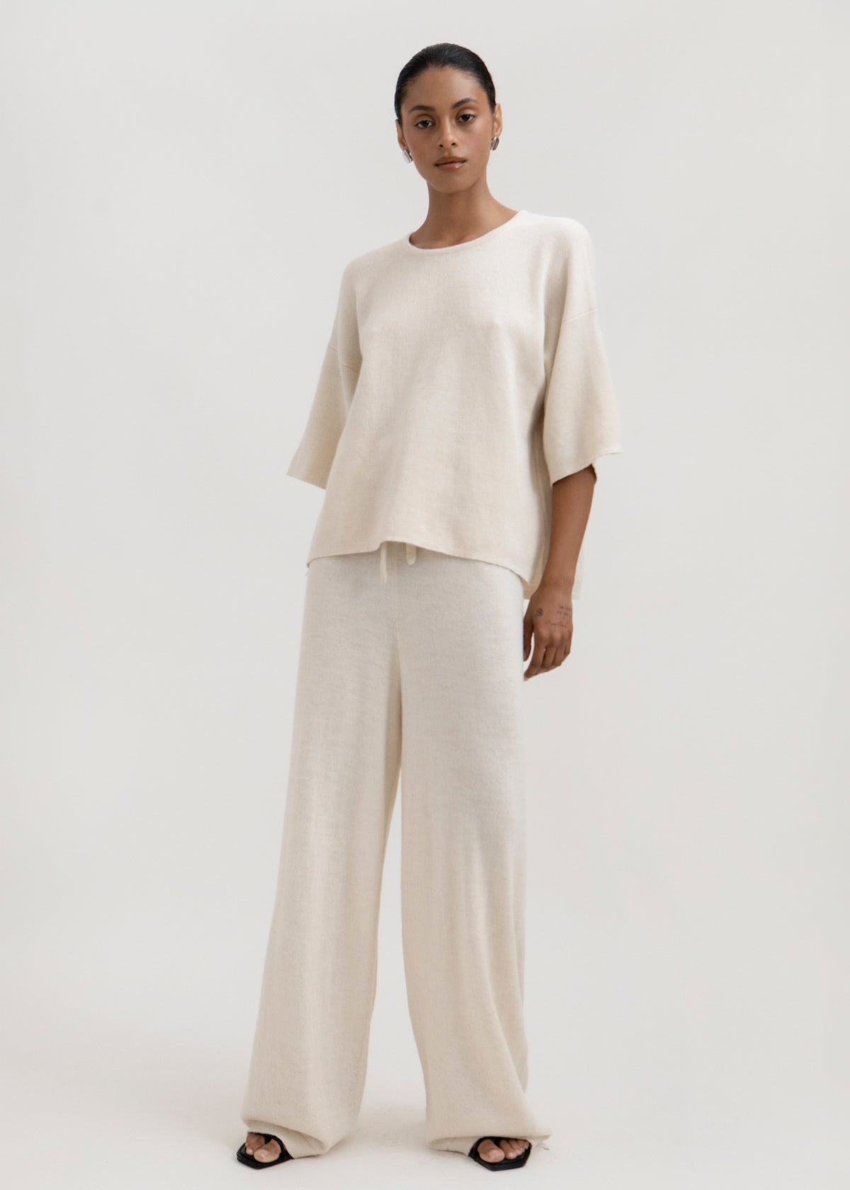 Avery Trousers in Cream, baby alpaca wide-leg knit trousers by Ahblo, worn by model