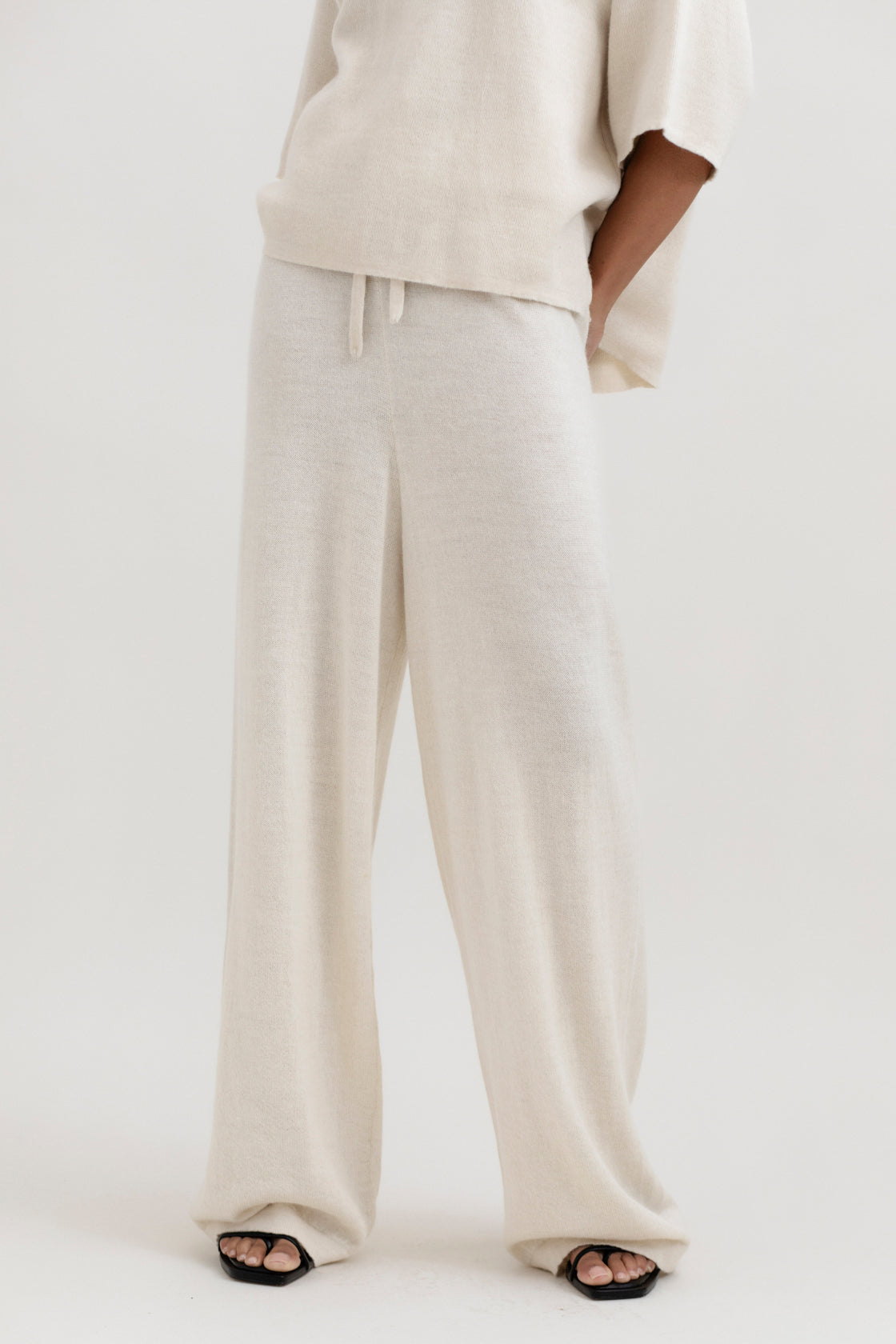 Avery Trousers in Cream, baby alpaca wide-leg knit trousers by Ahblo, worn by model