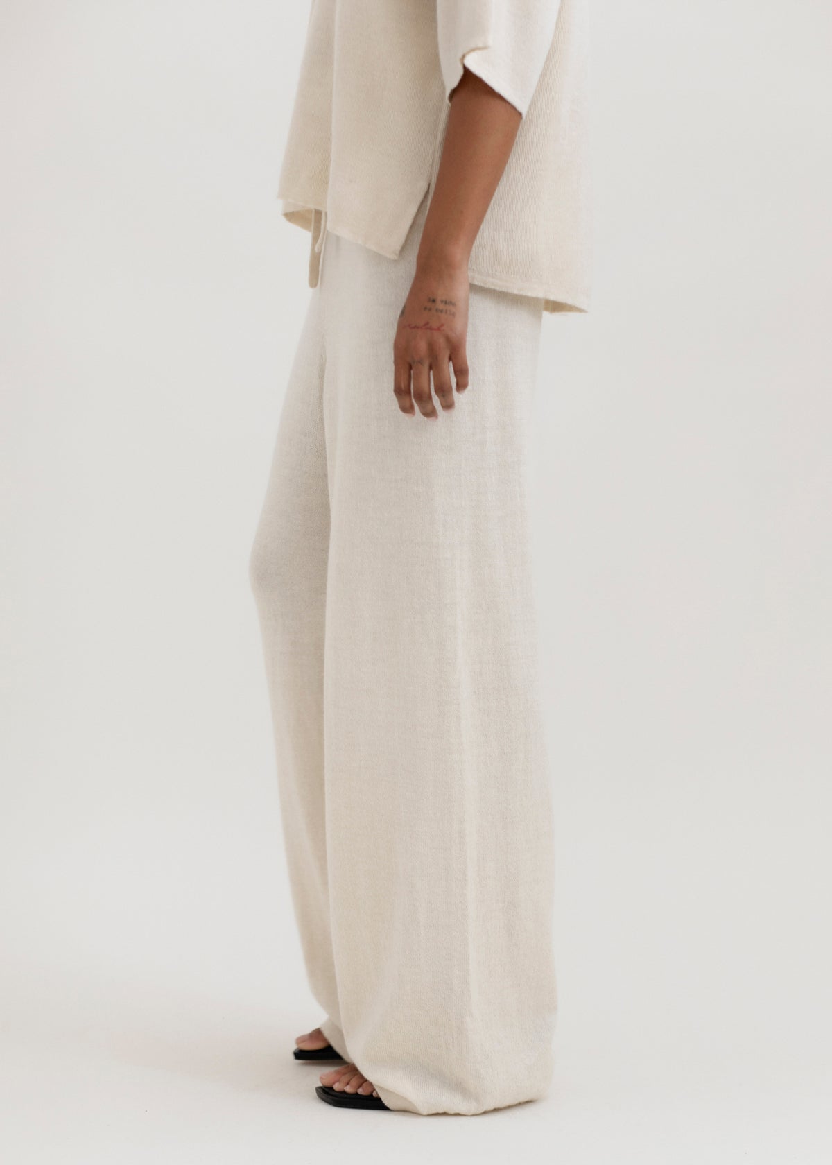 Avery Trousers in Cream, baby alpaca wide-leg knit trousers by Ahblo, worn by model