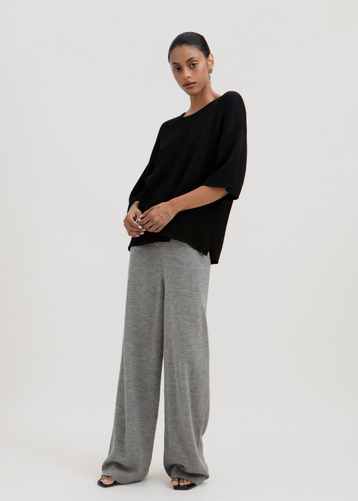 Avery Trousers in Mist Grey, baby alpaca wide-leg knit trousers by Ahblo, worn by model