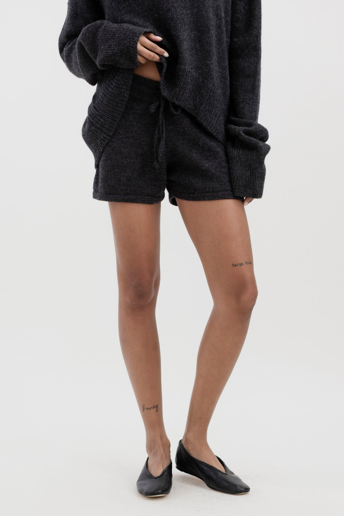 Cove Shorts in Charcoal, baby alpaca knit shorts by Ahblo, worn by model