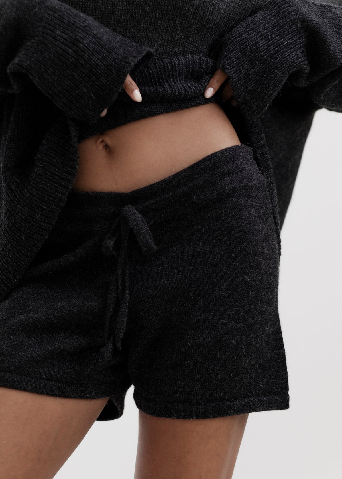 Cove Shorts in Charcoal, baby alpaca knit shorts by Ahblo, worn by model