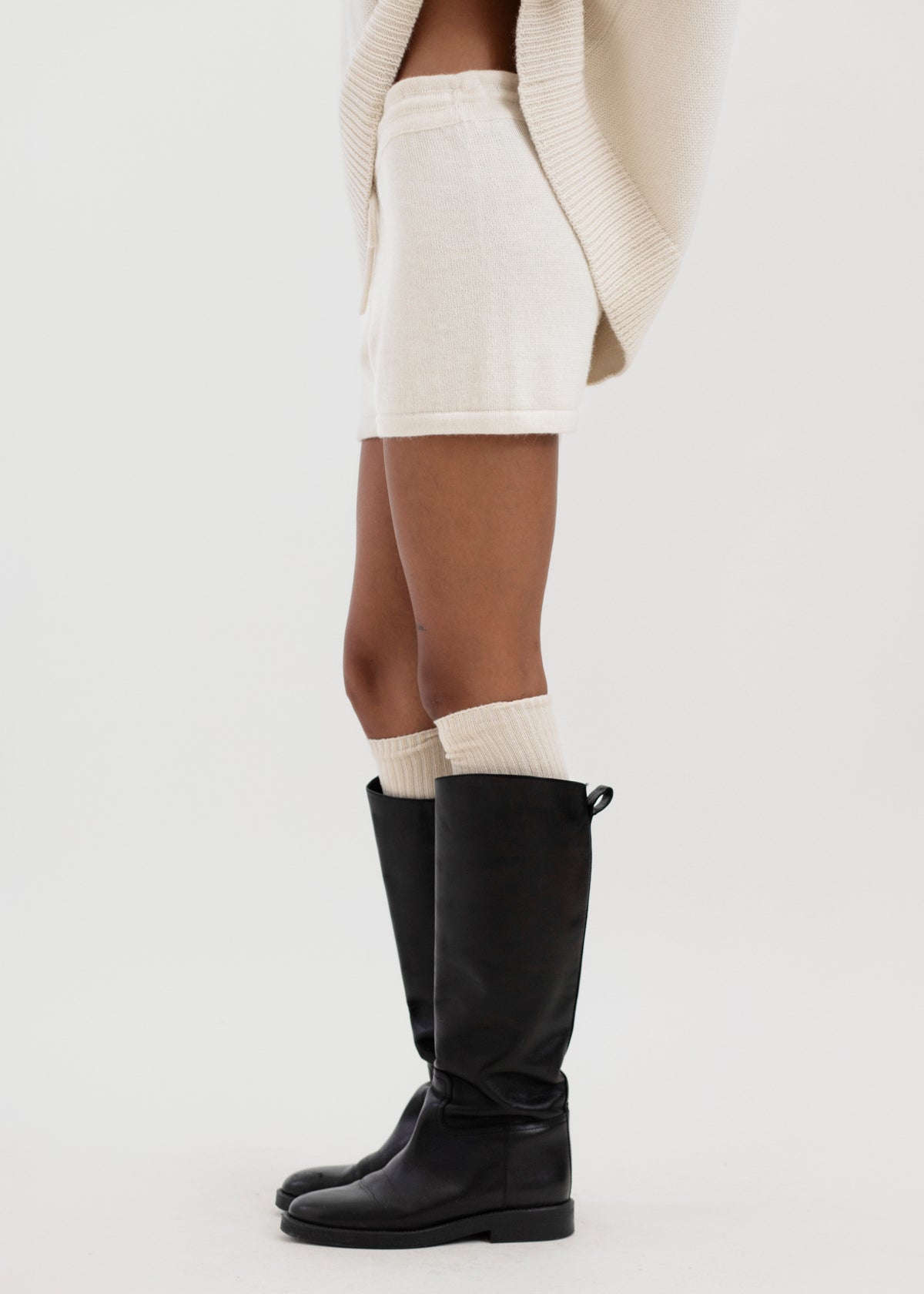 Cove Shorts in Cream, baby alpaca knit shorts by Ahblo, worn by model
