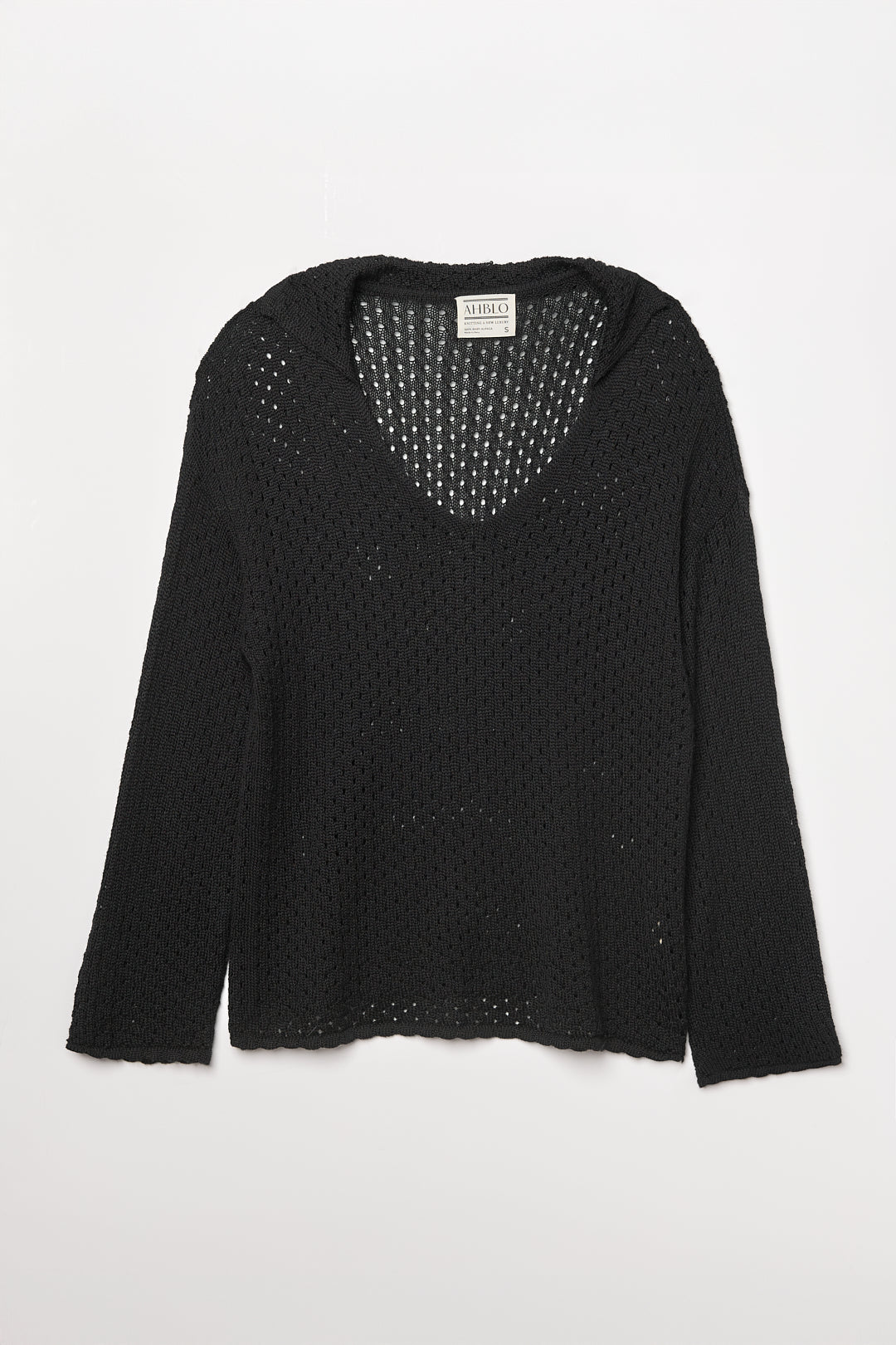 Haze Sweater in Black, baby alpaca crochet-knit sweater by Ahblo, flat lay