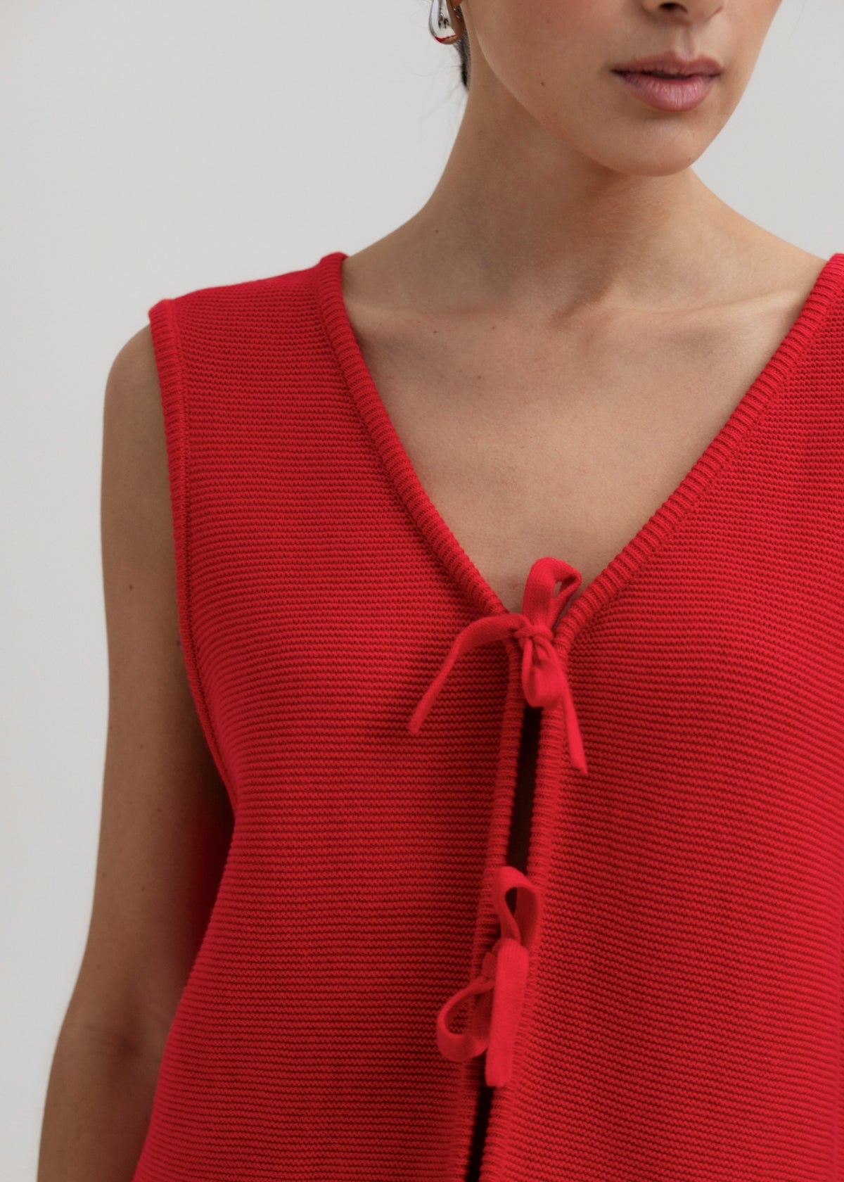 Luzia Vest in Cerise, cotton and baby alpaca knit vest by Ahblo, worn by model