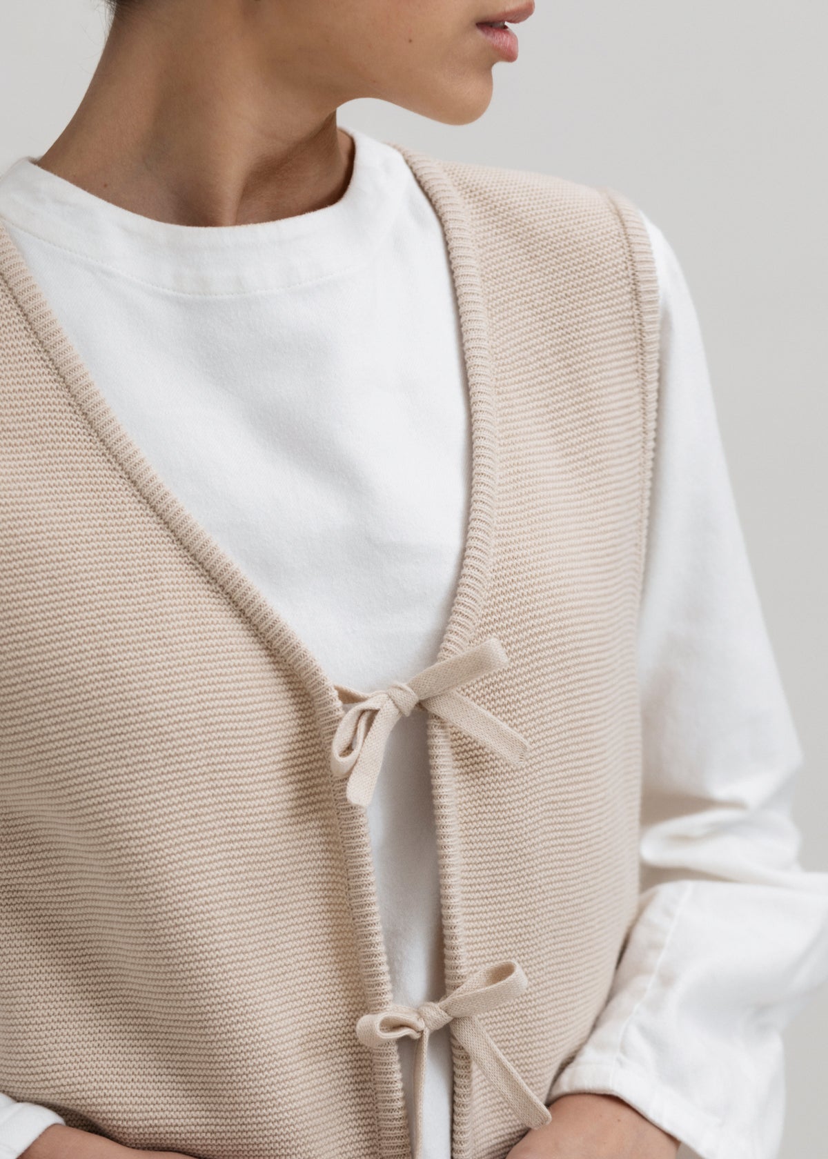Luzia Vest in Praline, cotton and baby alpaca knit vest by Ahblo, worn by model