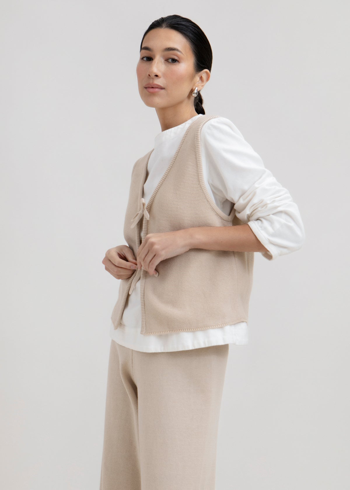Luzia Vest in Praline, cotton and baby alpaca knit vest by Ahblo, worn by model