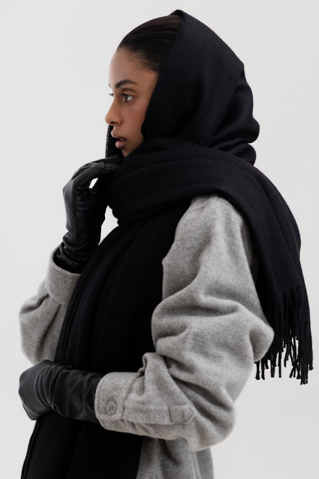 Riley Scarf in Black, blanket-size baby alpaca scarf by Ahblo, worn by model