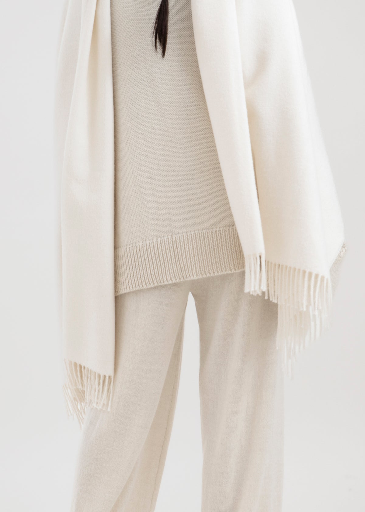 Riley Scarf in Cream, blanket-size baby alpaca scarf by Ahblo, worn by model