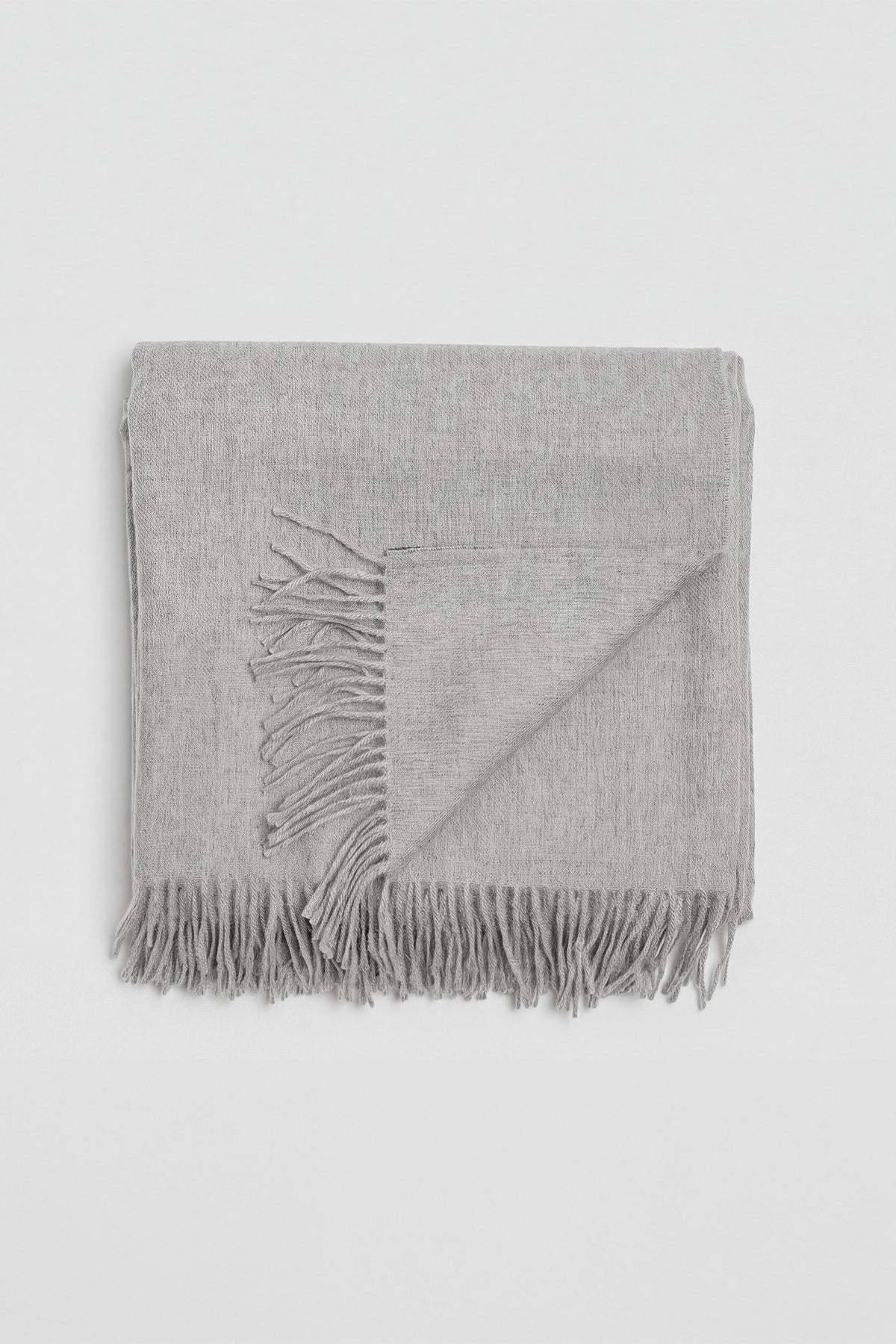 Riley Scarf in Mist Grey, blanket-size baby alpaca scarf by Ahblo, worn by model