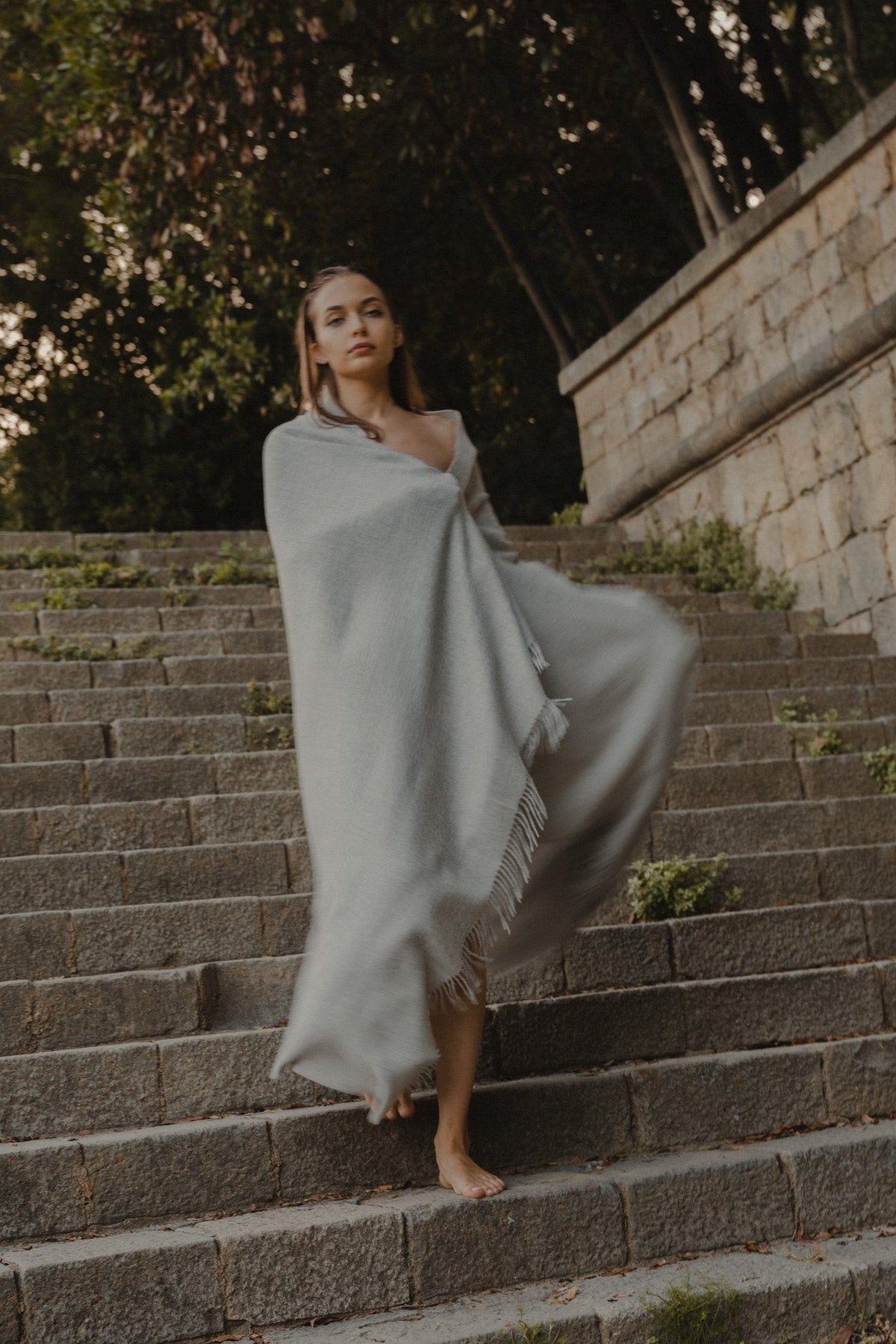 Riley Scarf in Mist Grey, blanket-size baby alpaca scarf by Ahblo, worn by model