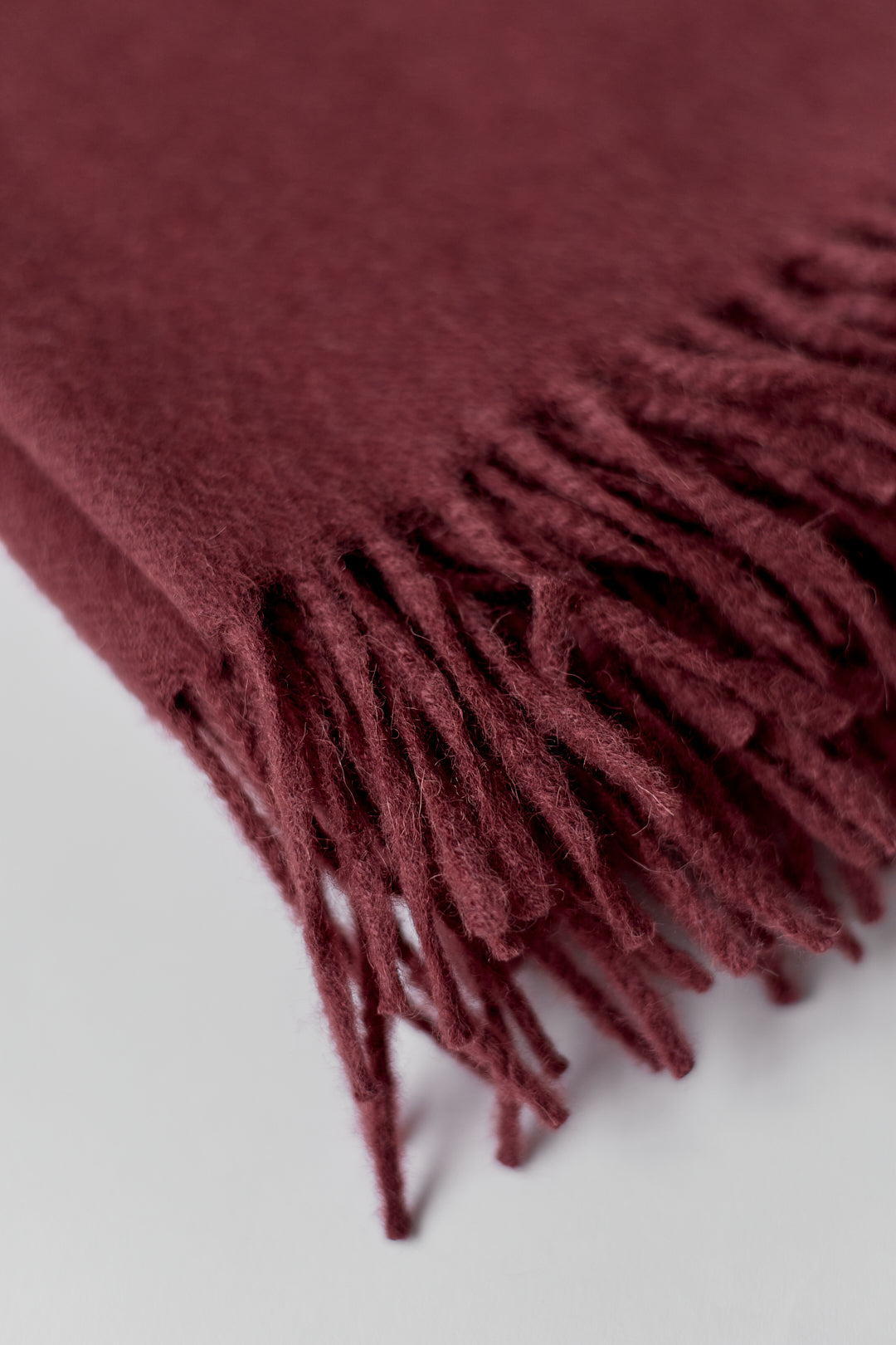 Rowan Scarf in Burgundy, fringed baby alpaca scarf by Ahblo, flat lay