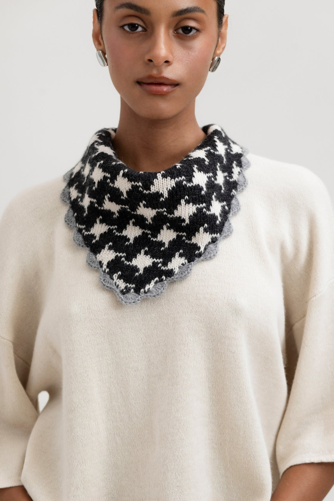 Tessa Scarf in Grey, reversible houndstooth baby alpaca triangle scarf by Ahblo, worn by model