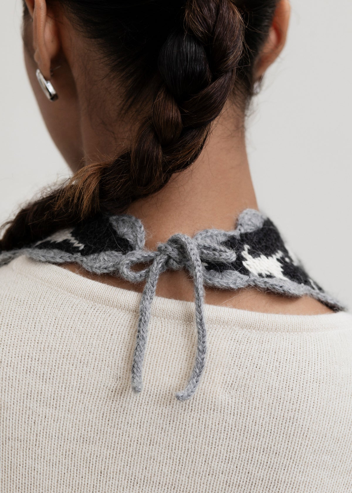 Tessa Scarf in Grey, reversible houndstooth baby alpaca triangle scarf by Ahblo, worn by model