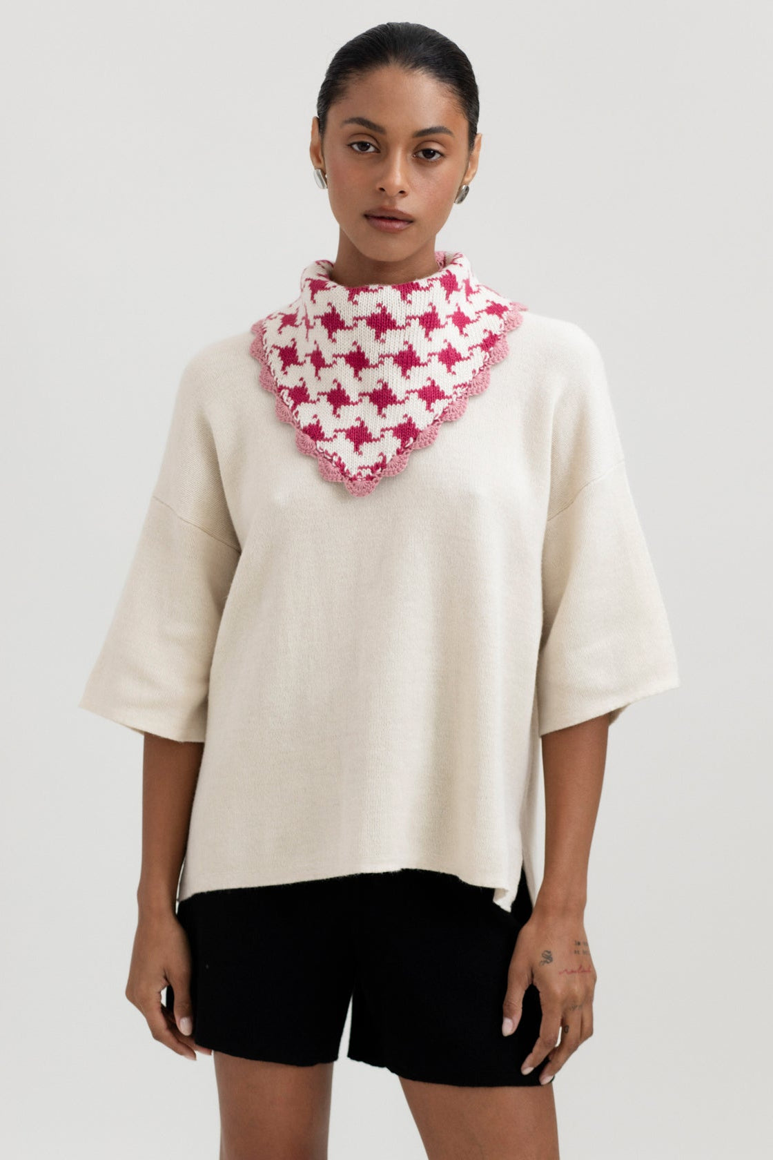 Tessa Scarf in Wild Rose, reversible houndstooth baby alpaca triangle scarf by Ahblo, worn by model