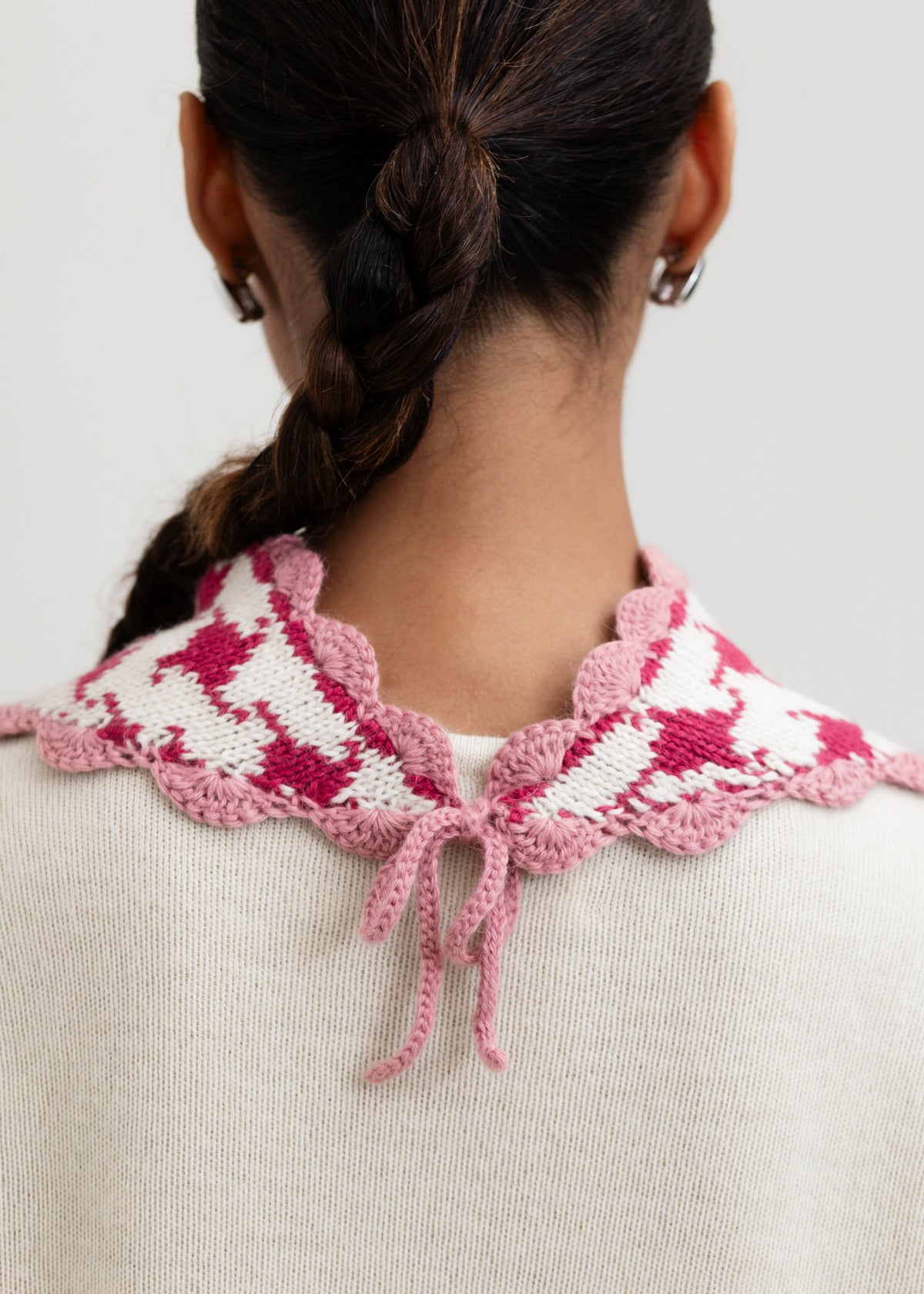 Tessa Scarf in Wild Rose, reversible houndstooth baby alpaca triangle scarf by Ahblo, worn by model