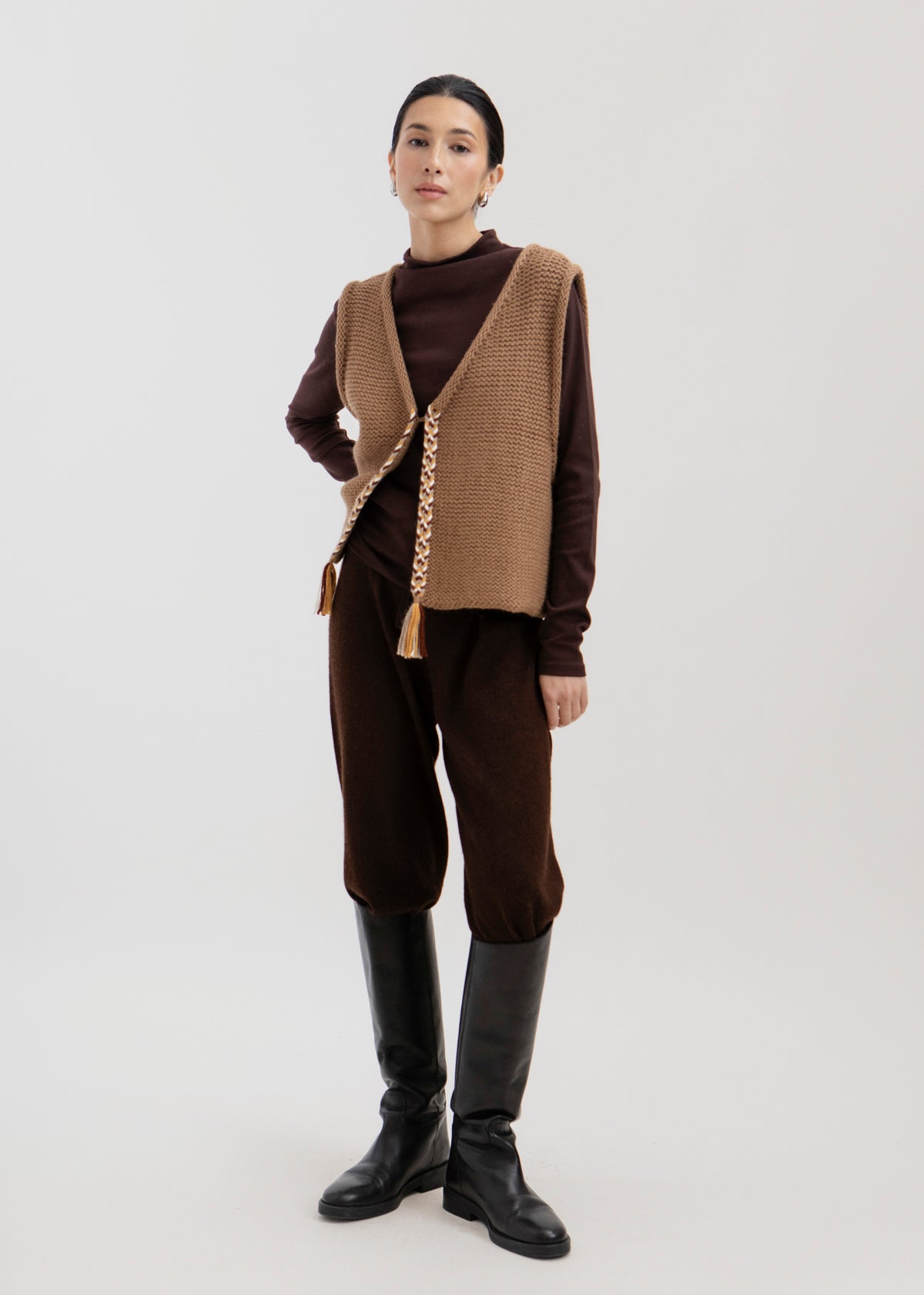 Vela Braid Vest in Caramel, baby alpaca knit vest with hand-braided trim by Ahblo, worn by model