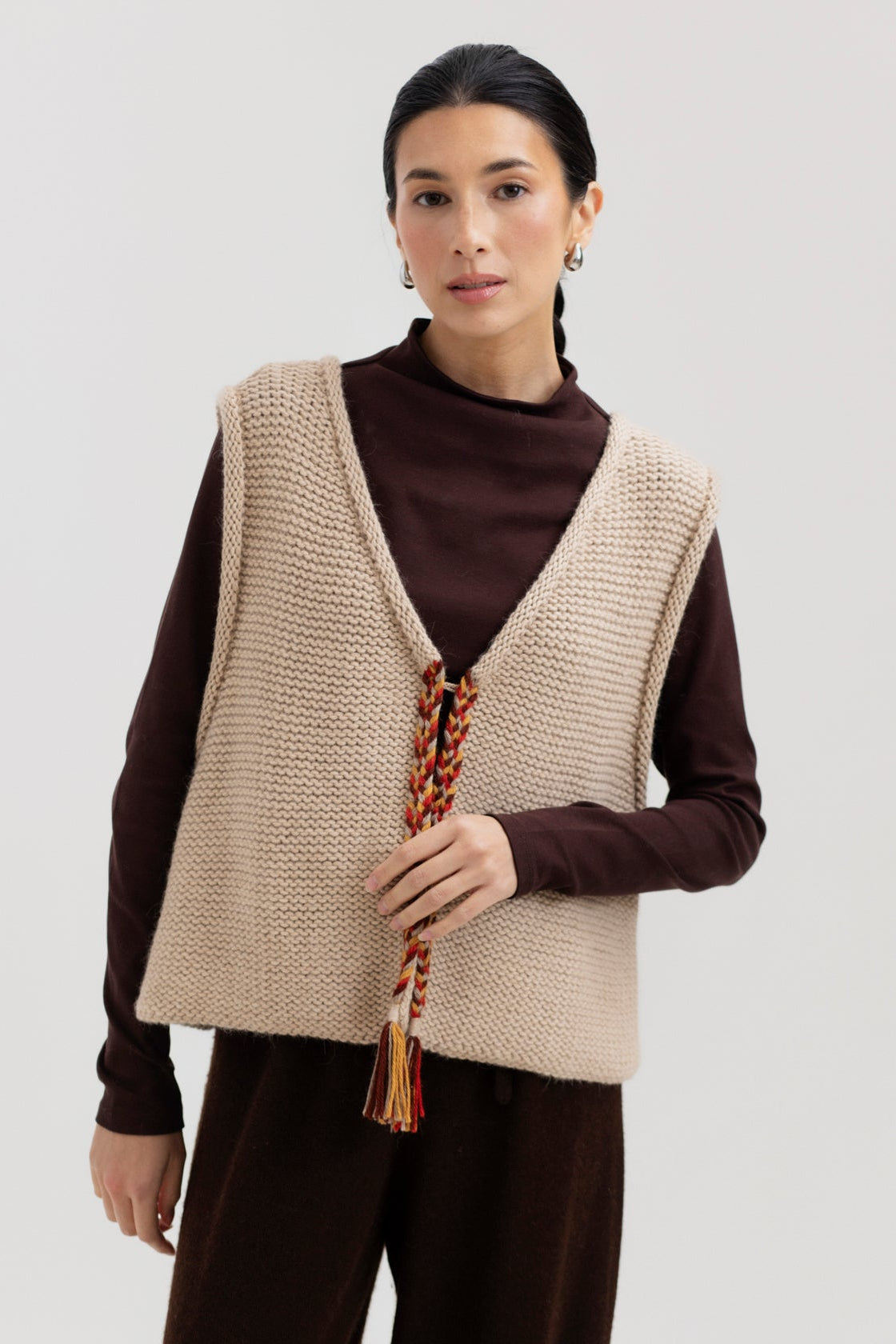 Vela Braid Vest in Praline, baby alpaca knit vest with hand-braided trim by Ahblo, worn by model