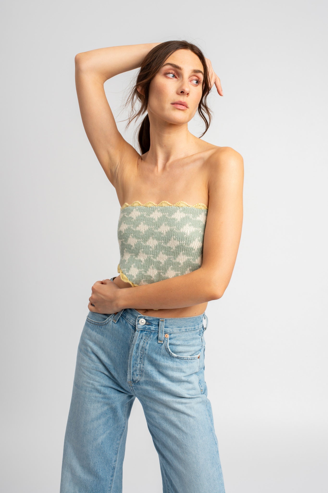 Model wearing knitwear, alpaca wool headscarf in white & sage on body, standing