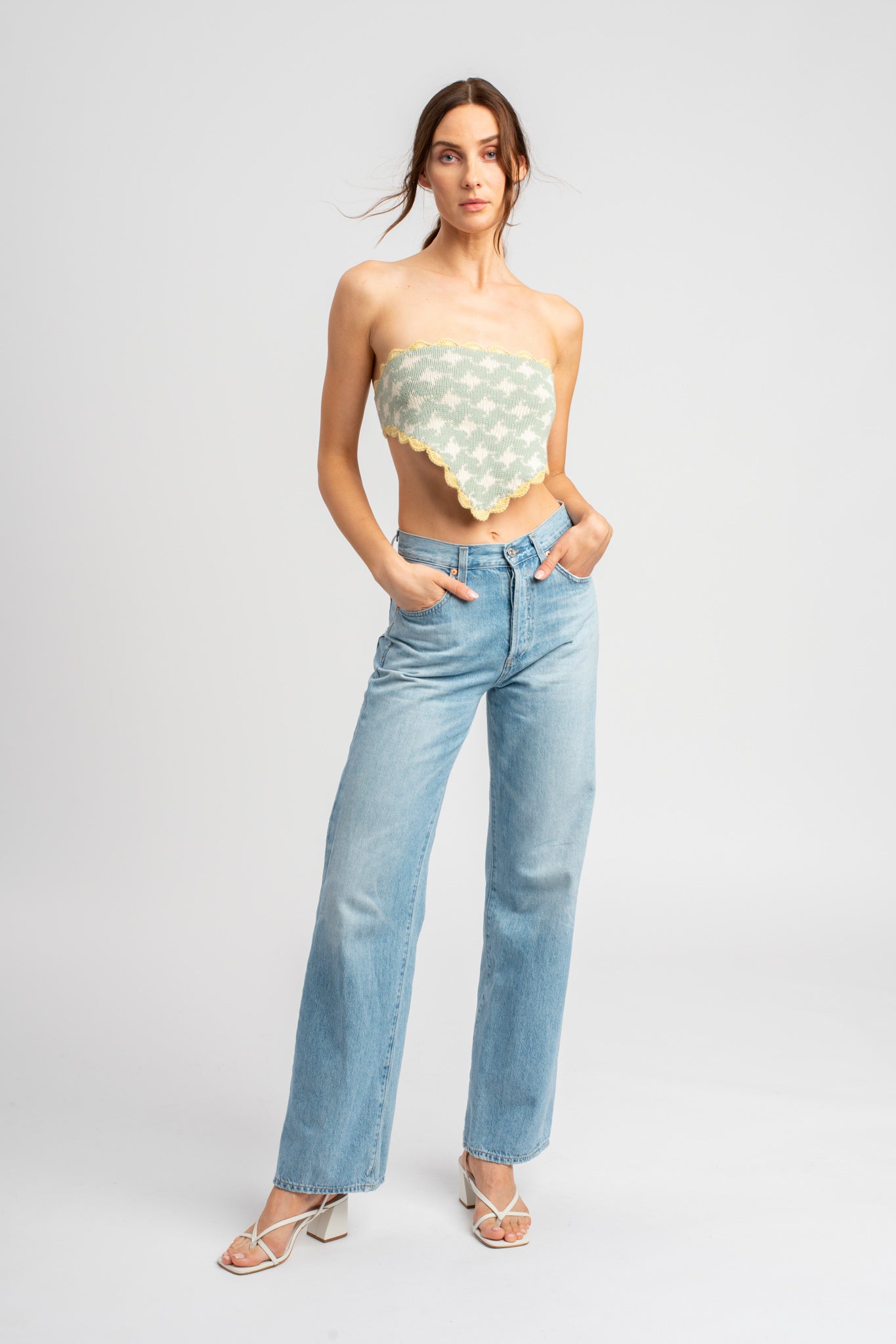 Model wearing knitwear, alpaca wool headscarf in white & sage on body, front