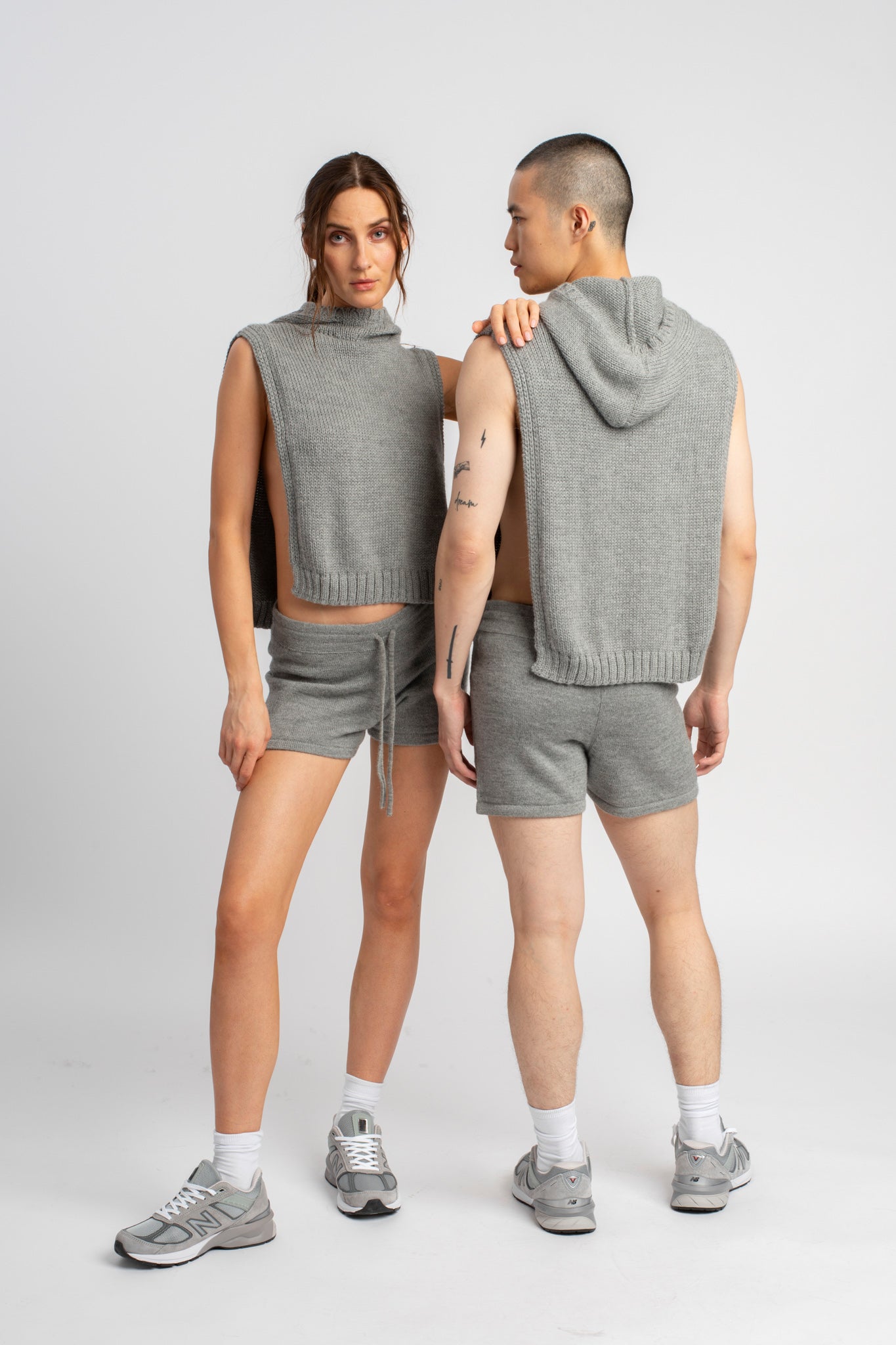 Models wearing knitwear alpaca wool light grey shorts, front and back views