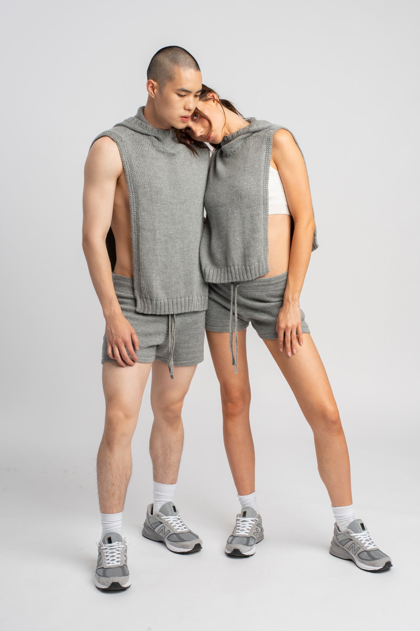 Models wearing knitwear alpaca wool light grey shorts with matching ponchos