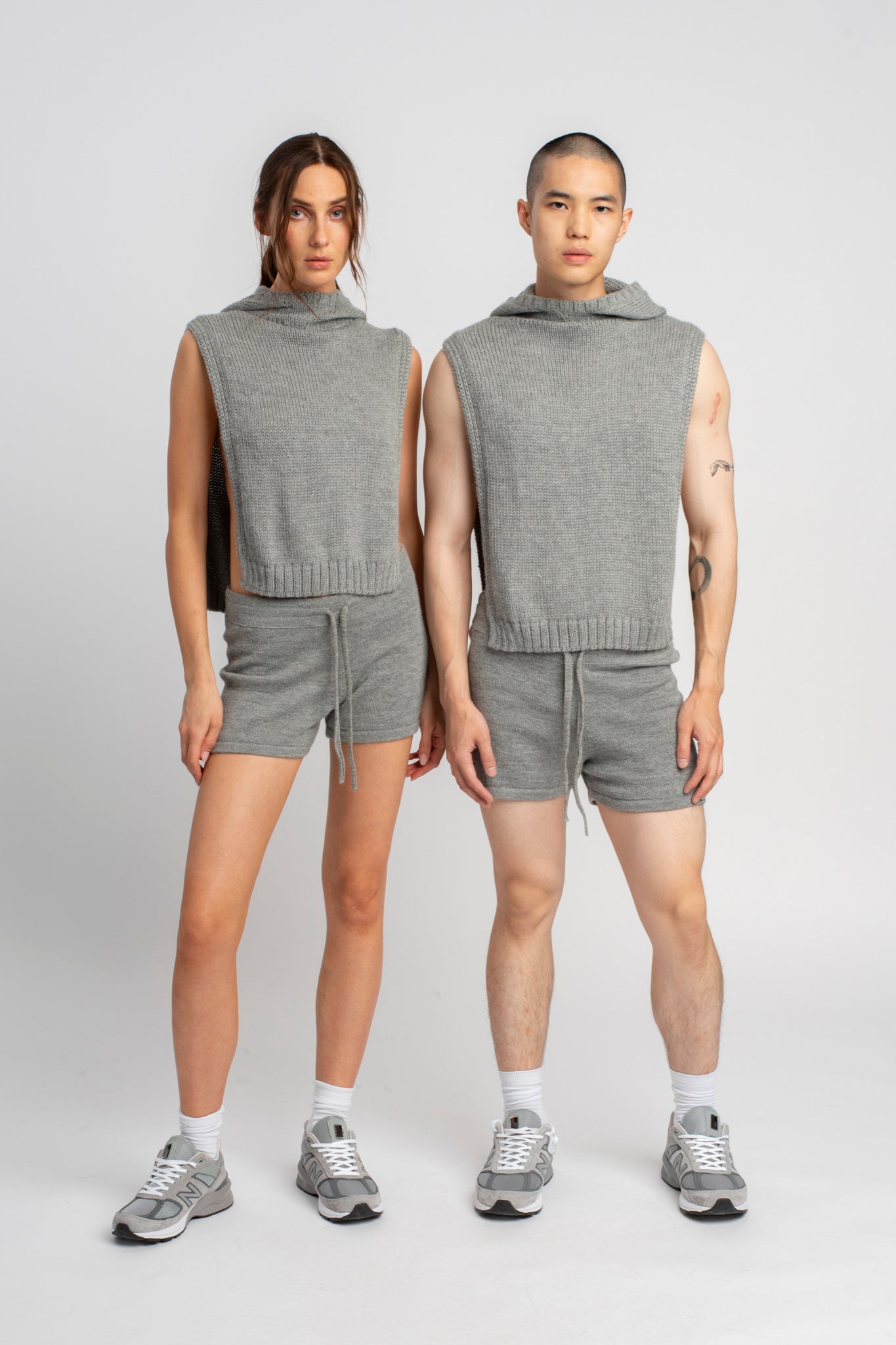 Models wearing knitwear alpaca wool light grey shorts, front side by side