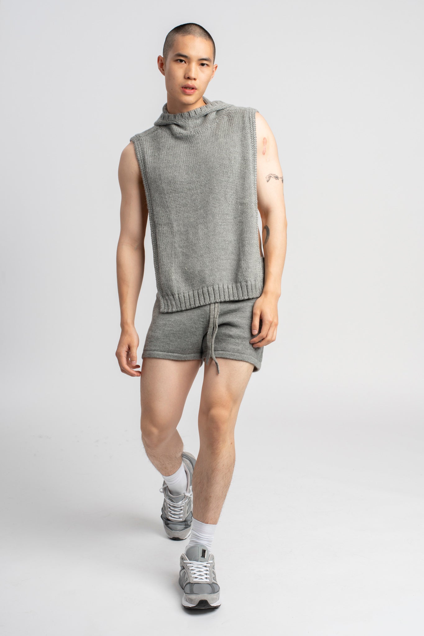 Model wearing knitwear alpaca wool light grey shorts & matching top, front standing