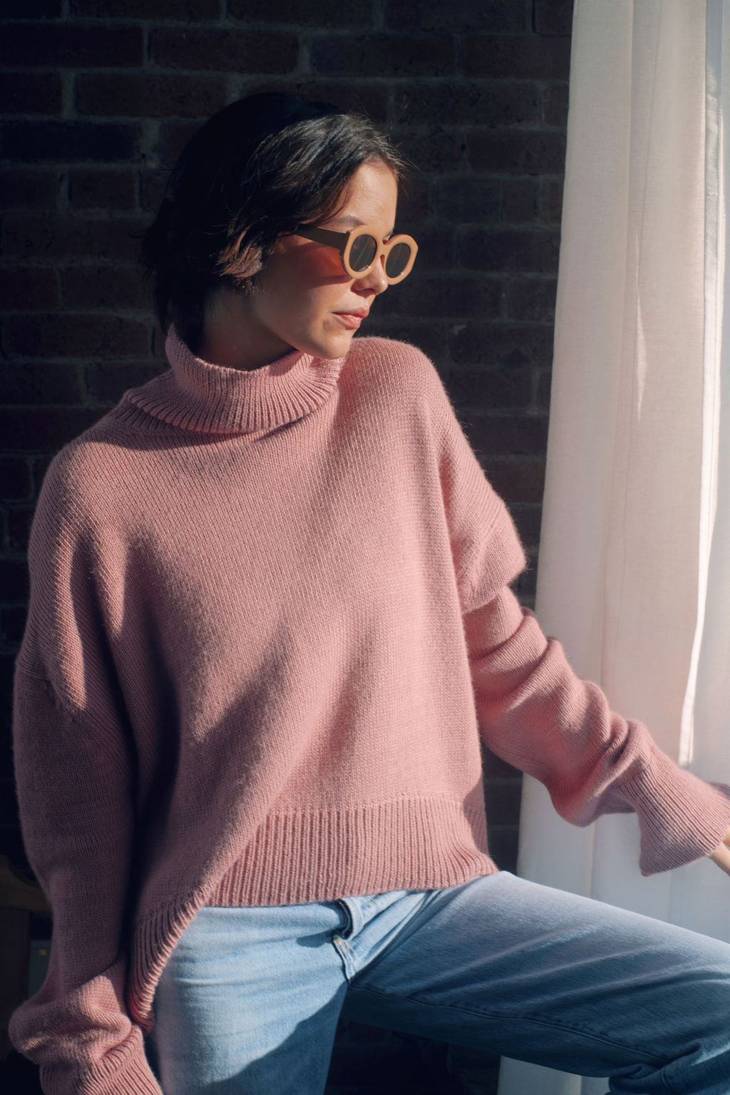 Model wearing oversized sweater in light pink alpaca wool, front