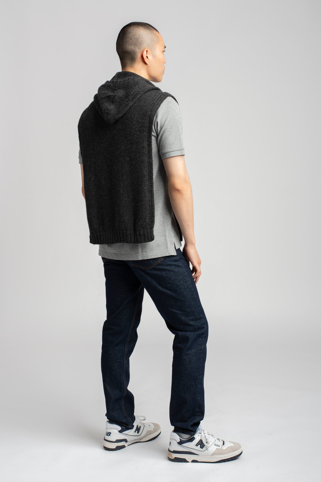 Model wearing poncho in dark grey alpaca wool, back