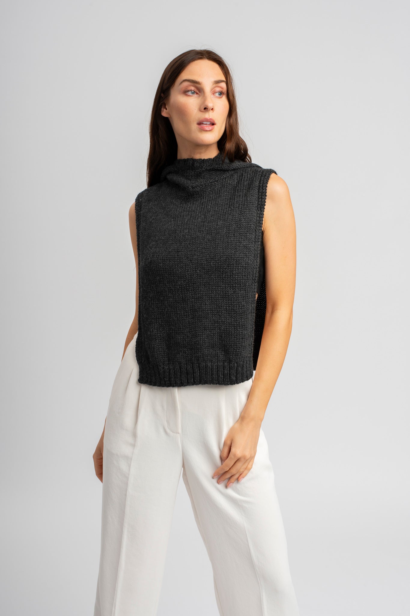 Model wearing poncho in dark grey alpaca wool, front