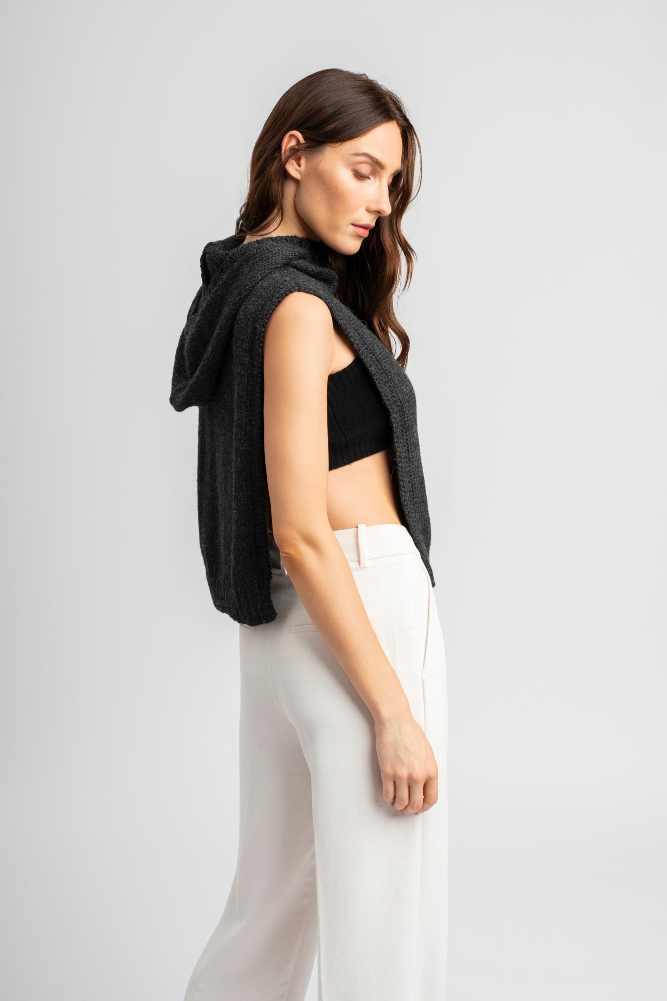 Model wearing poncho in dark grey alpaca wool, side standing