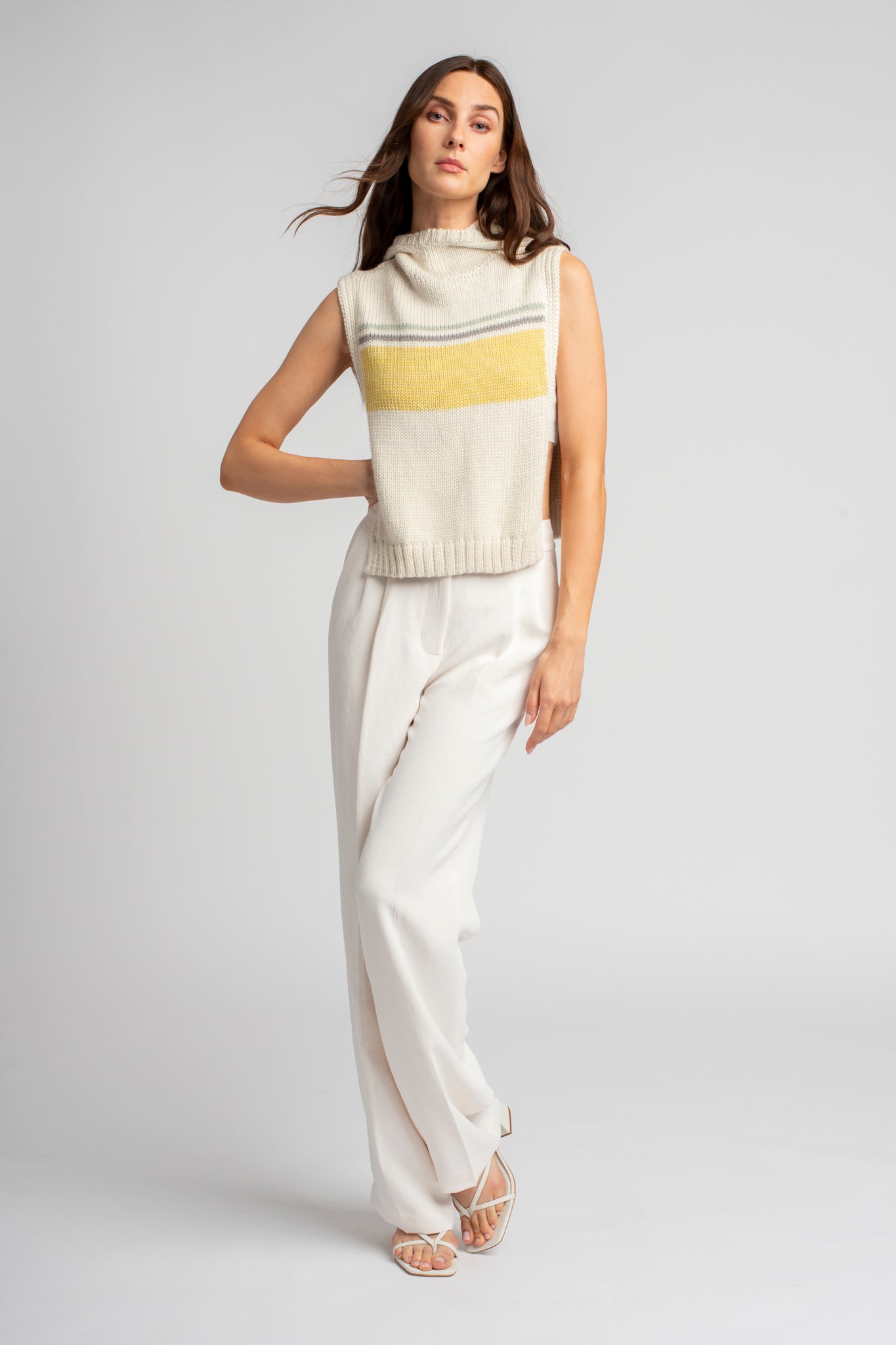 Model wearing poncho, alpaca wool in yellow ocean stripes, front