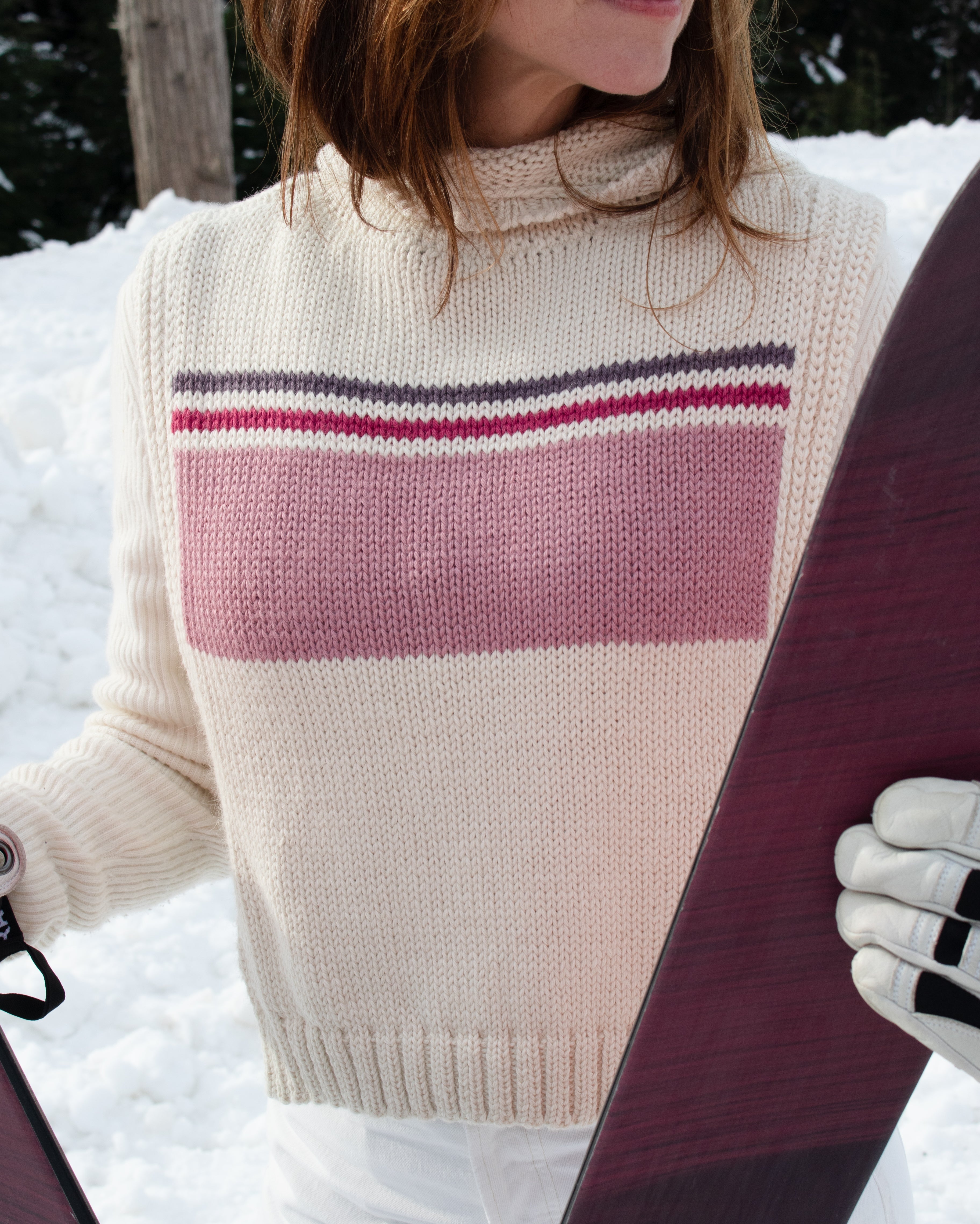 Model wearing poncho in pink baby alpaca wool, close-up