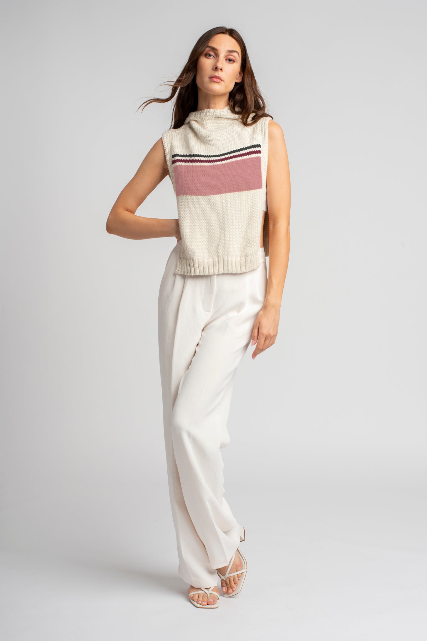 Model wearing poncho in pink baby alpaca wool, far