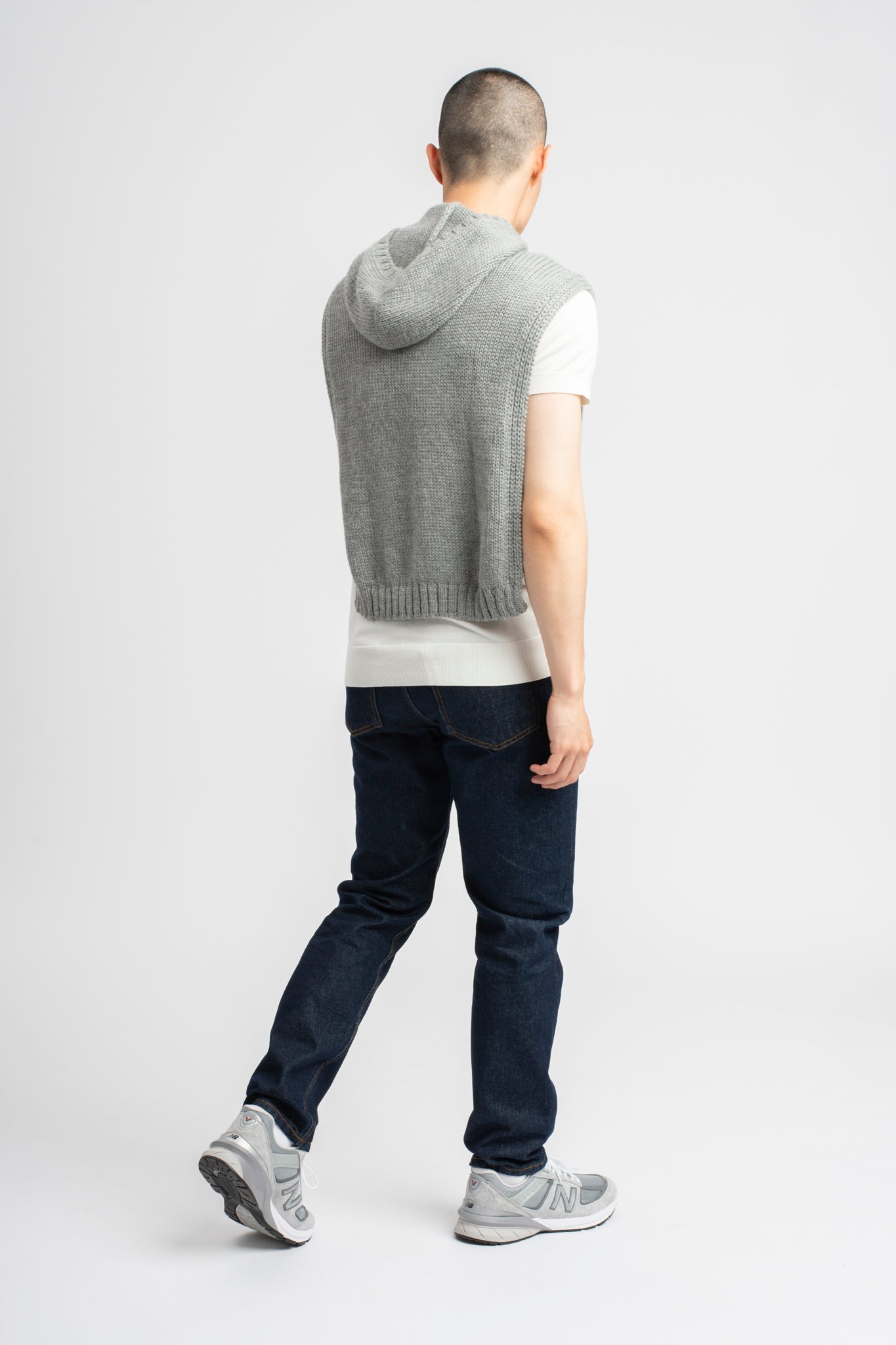 Model wearing poncho in light grey alpaca wool, back